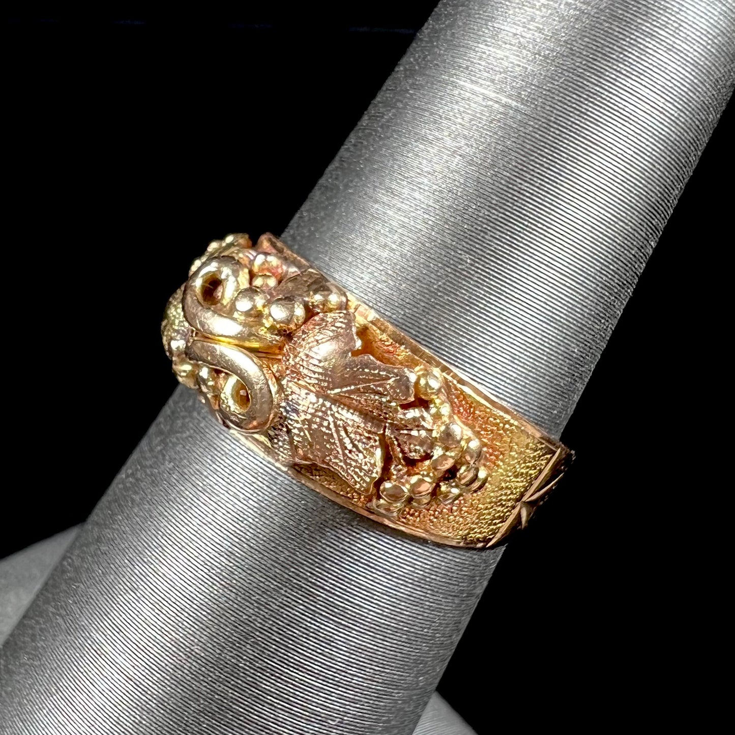 A ladies' two-tone Black Hills gold ring featuring the motif of leaves. The inside of the ring is stamped "16K" and "BARCLAY".