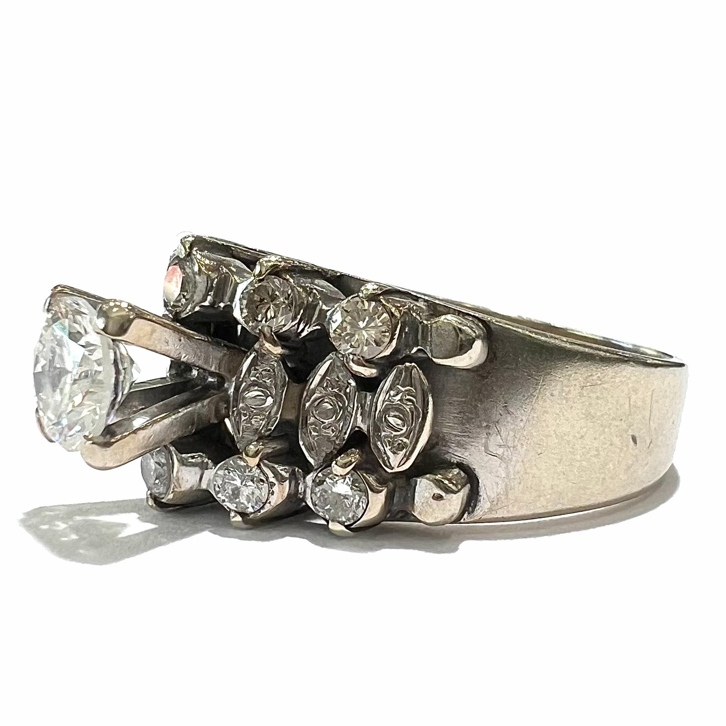 A vintage, 1940's style white gold diamond wedding ring set with a 0.68ct round diamond. The diamond has a noticeable black crystal inclusion.