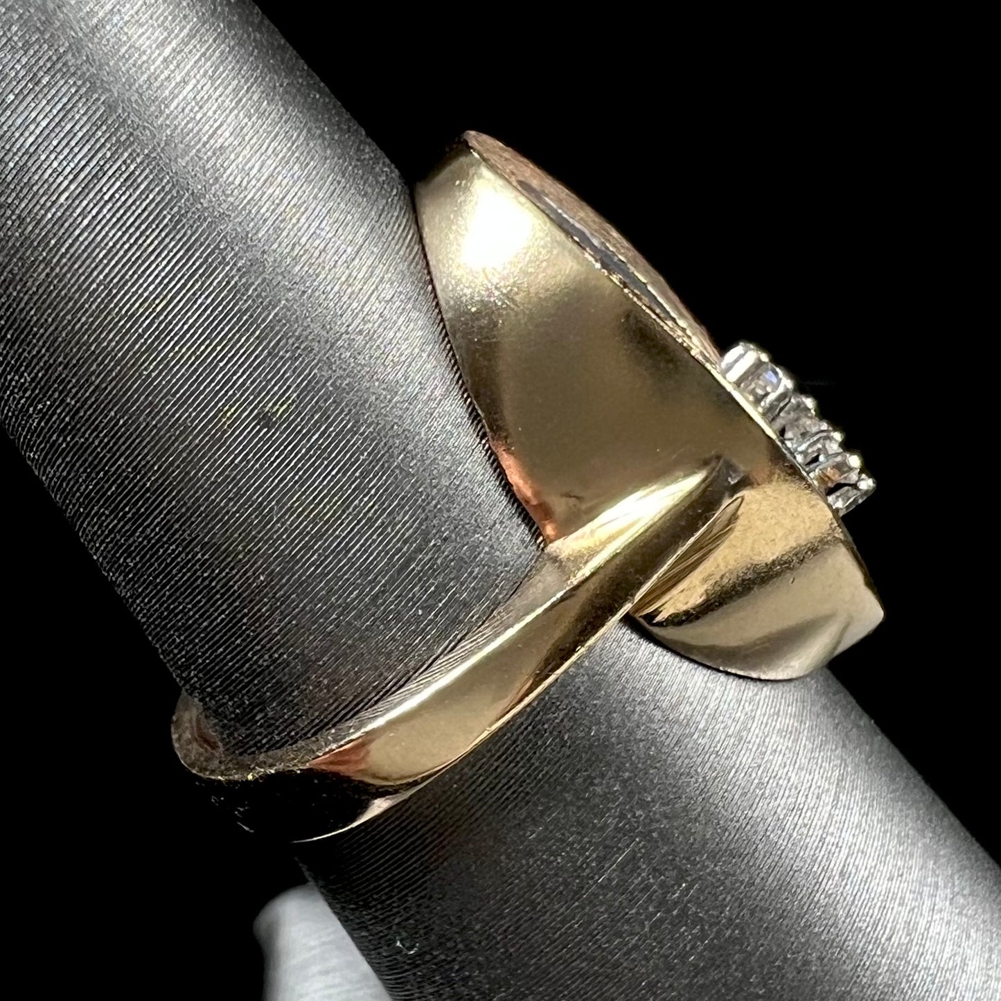 A vintage mosaic opal ring set with diamond accents in 10 karat yellow and white gold.