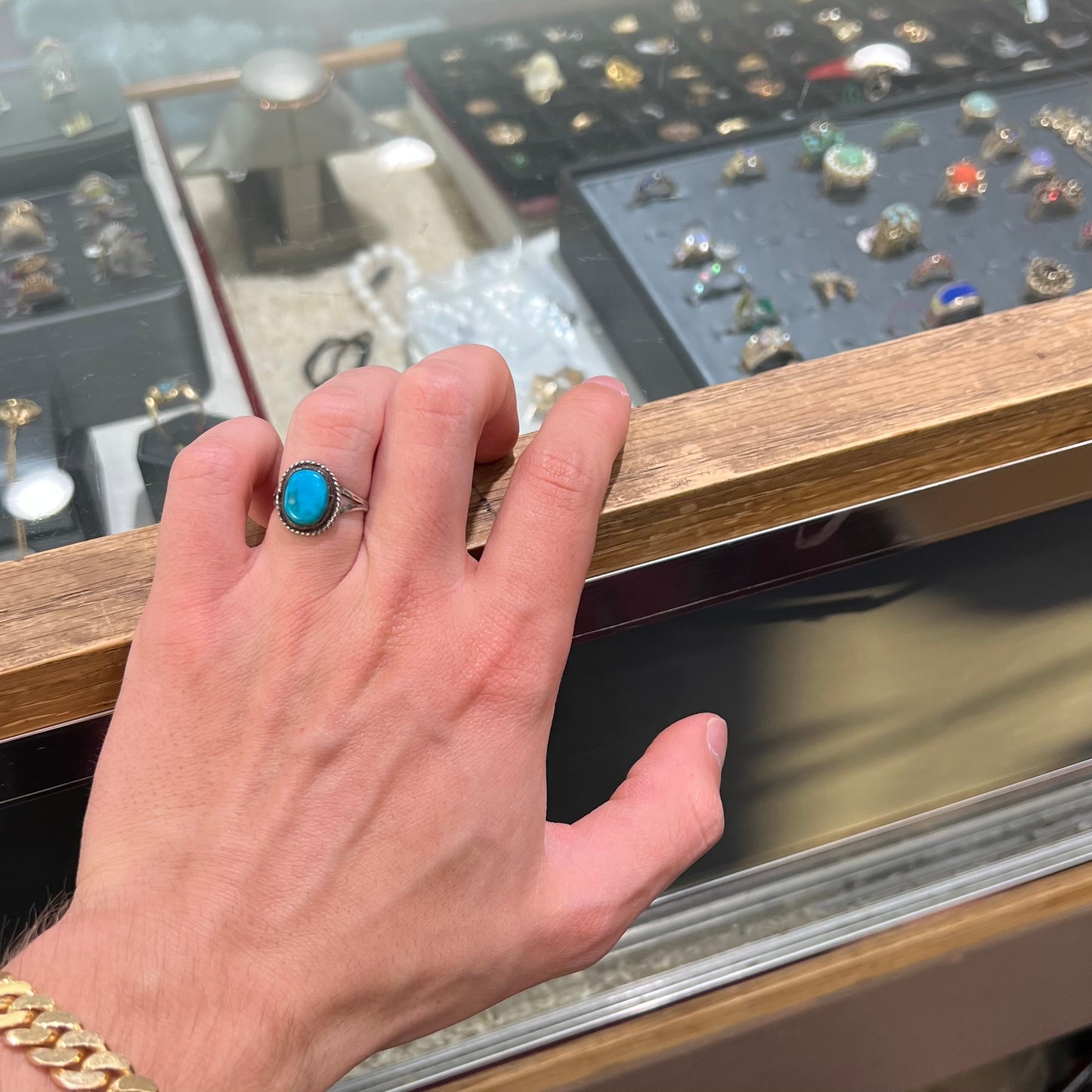 A vintage ladies' Pilot Mountain turquoise ring handmade in sterling silver with a rope accented bezel.
