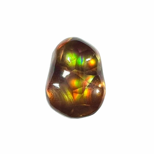 A loose, freefrom cabochon cut Mexican fire agate stone.  The stone has red, green, yellow, and purple banding.