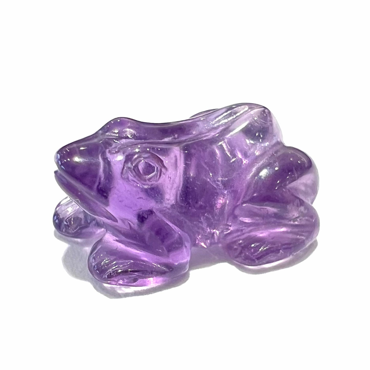 A stone frog carved from purple amethyst crystal. The gem weighs 3.28 carats.