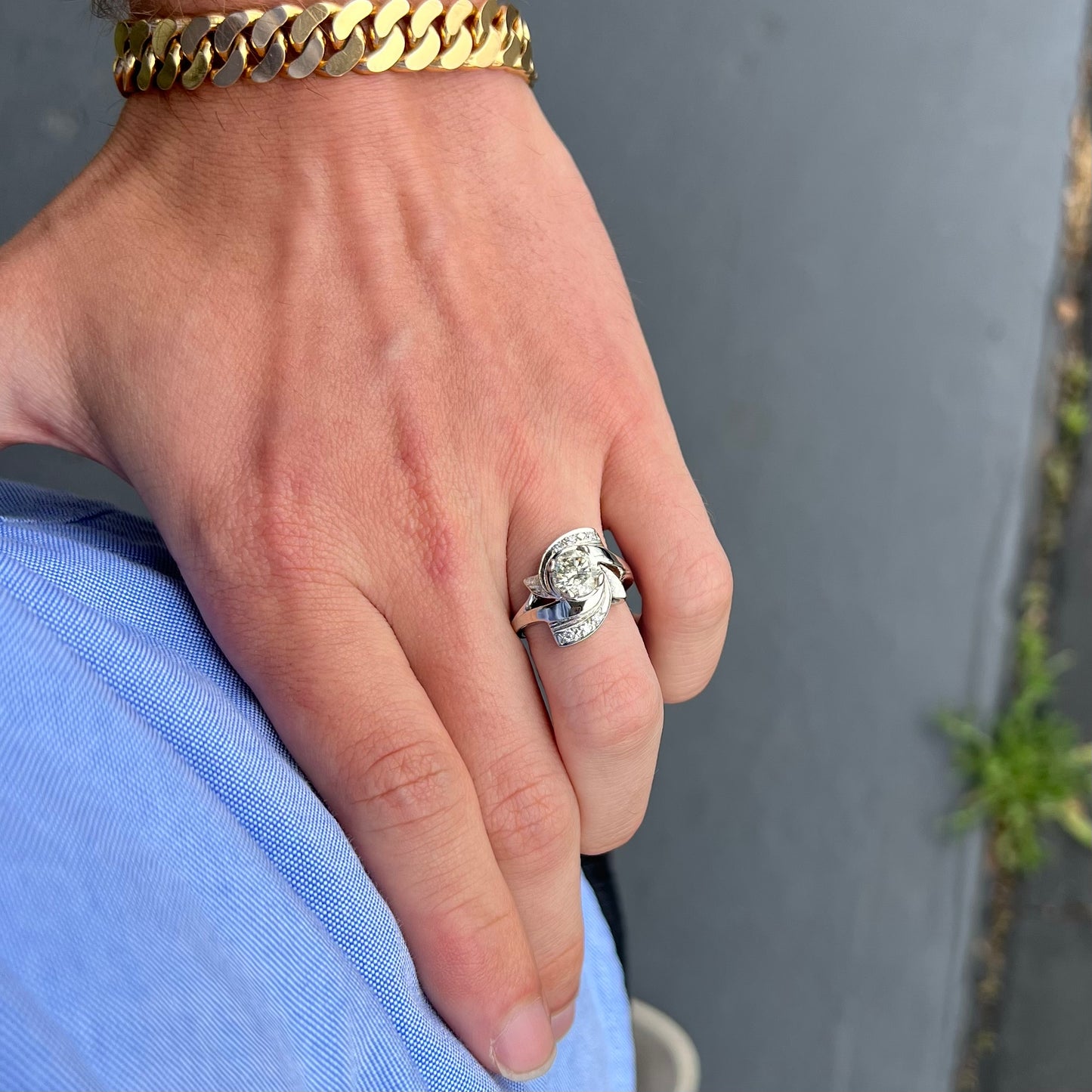 A vintage, Art Nouveau style diamond engagment ring. The ring is white gold with a yellowish, M colored, 1.24 carat diamond.