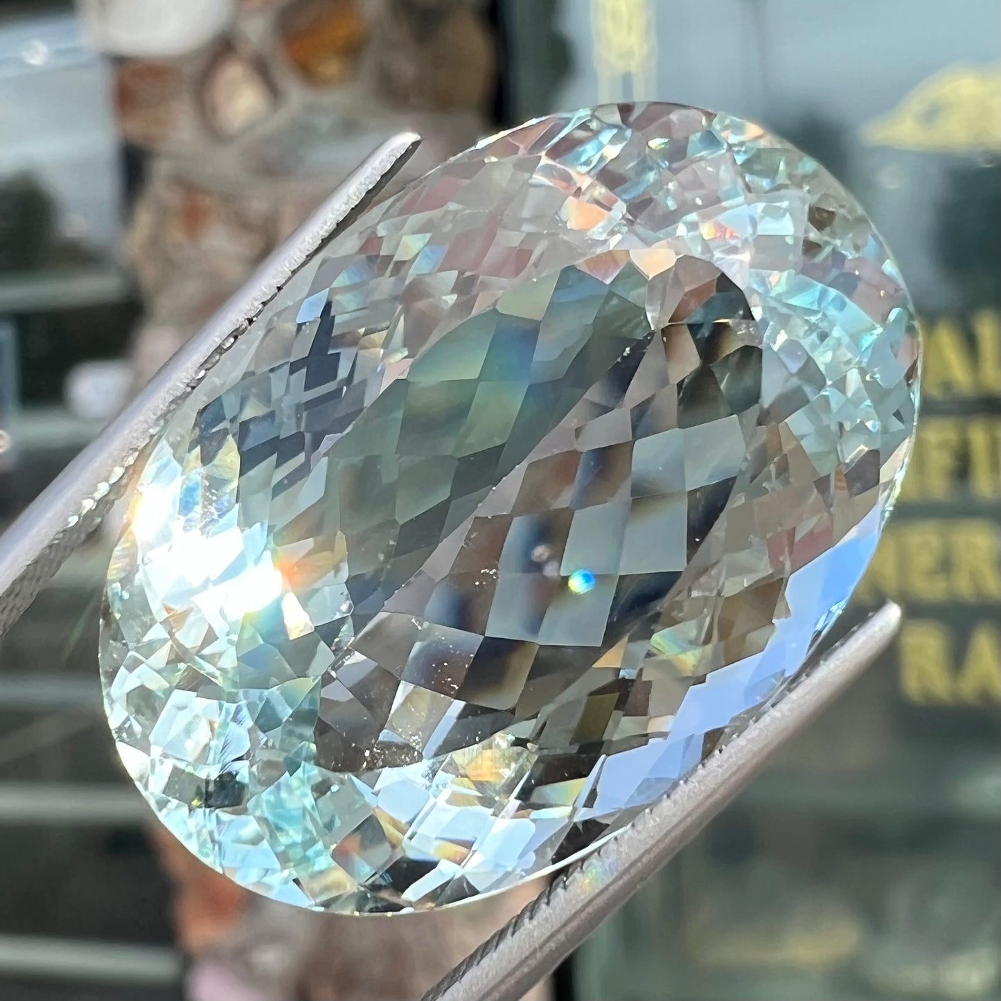 A faceted oval cut Brazilian aquamarine gemstone. The stone is a light blue color.