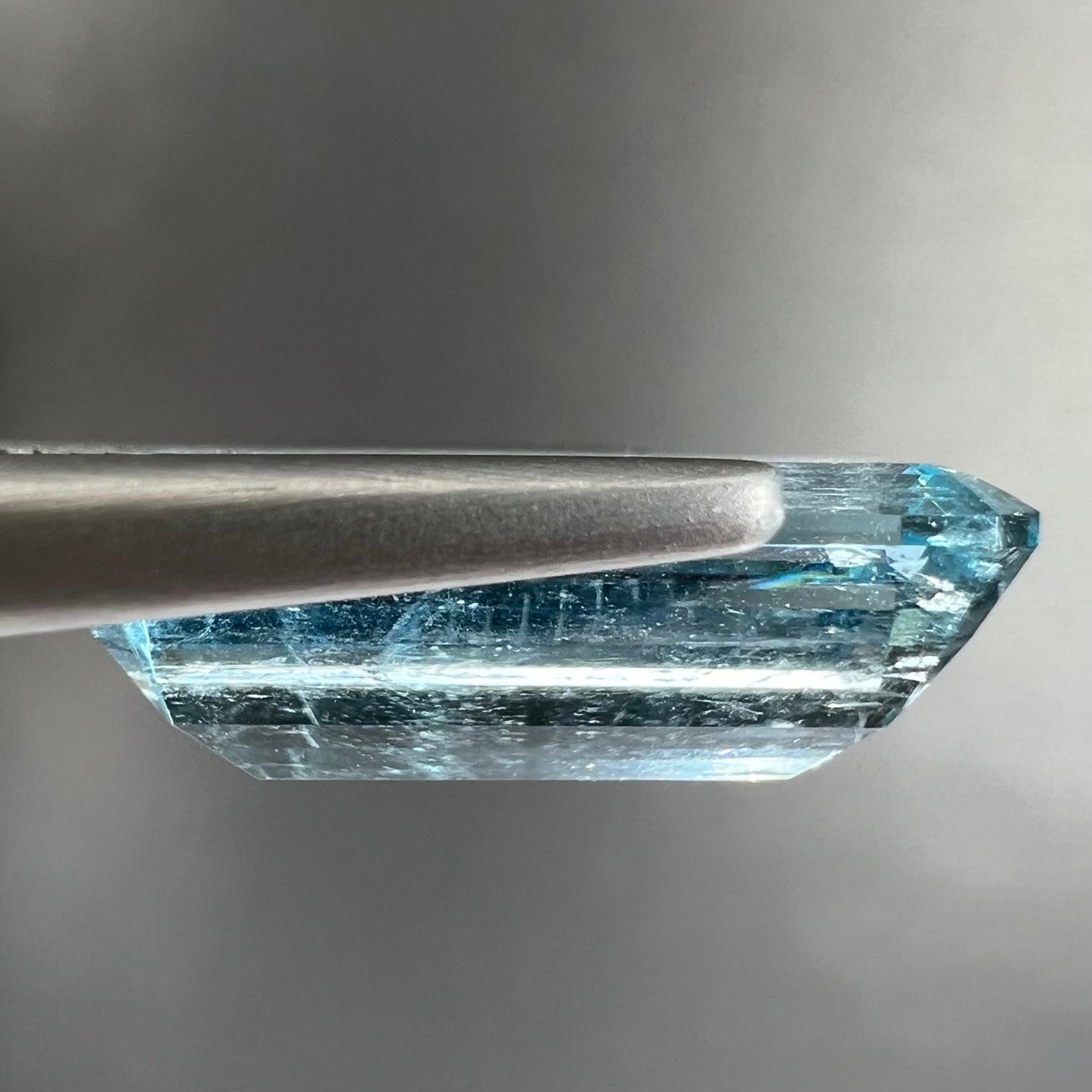 A loose, emerald cut aquamarine stone from Vietnam. The stone is an ice blue color.