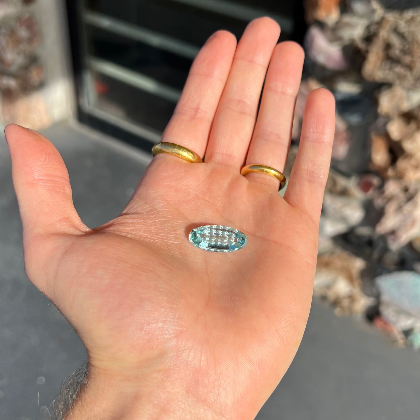 An oval fantasy cut greenish blue aquamarine stone cut by gem carver, Arthur Lee Anderson.