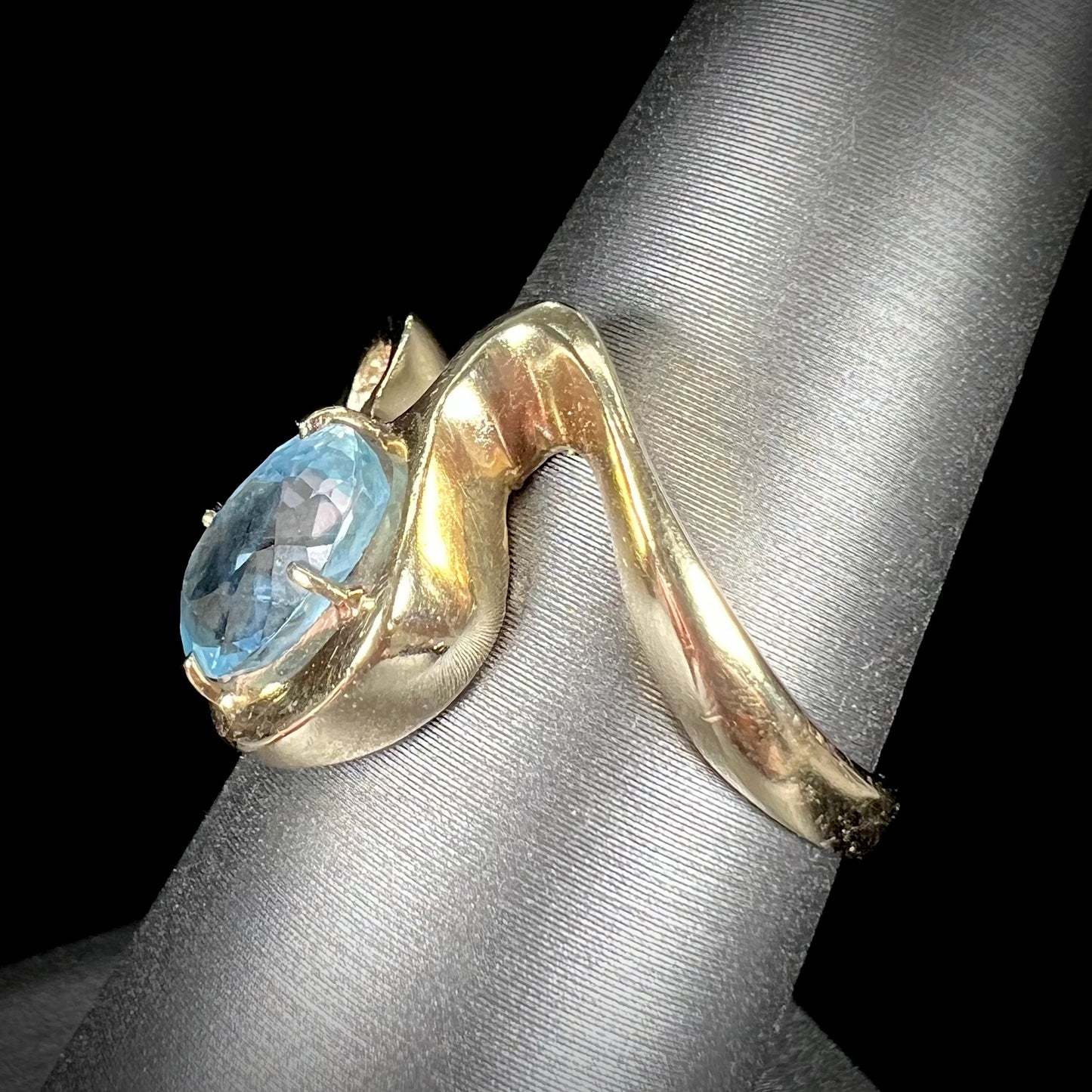 A ladies' estate yellow gold aquamarine solitaire ring. The aquamarine is oval cut.