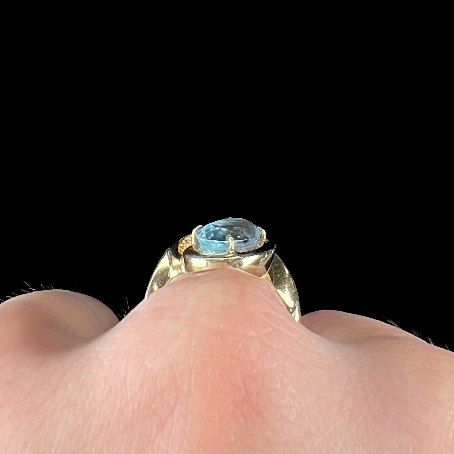 A ladies' estate yellow gold aquamarine solitaire ring. The aquamarine is oval cut.