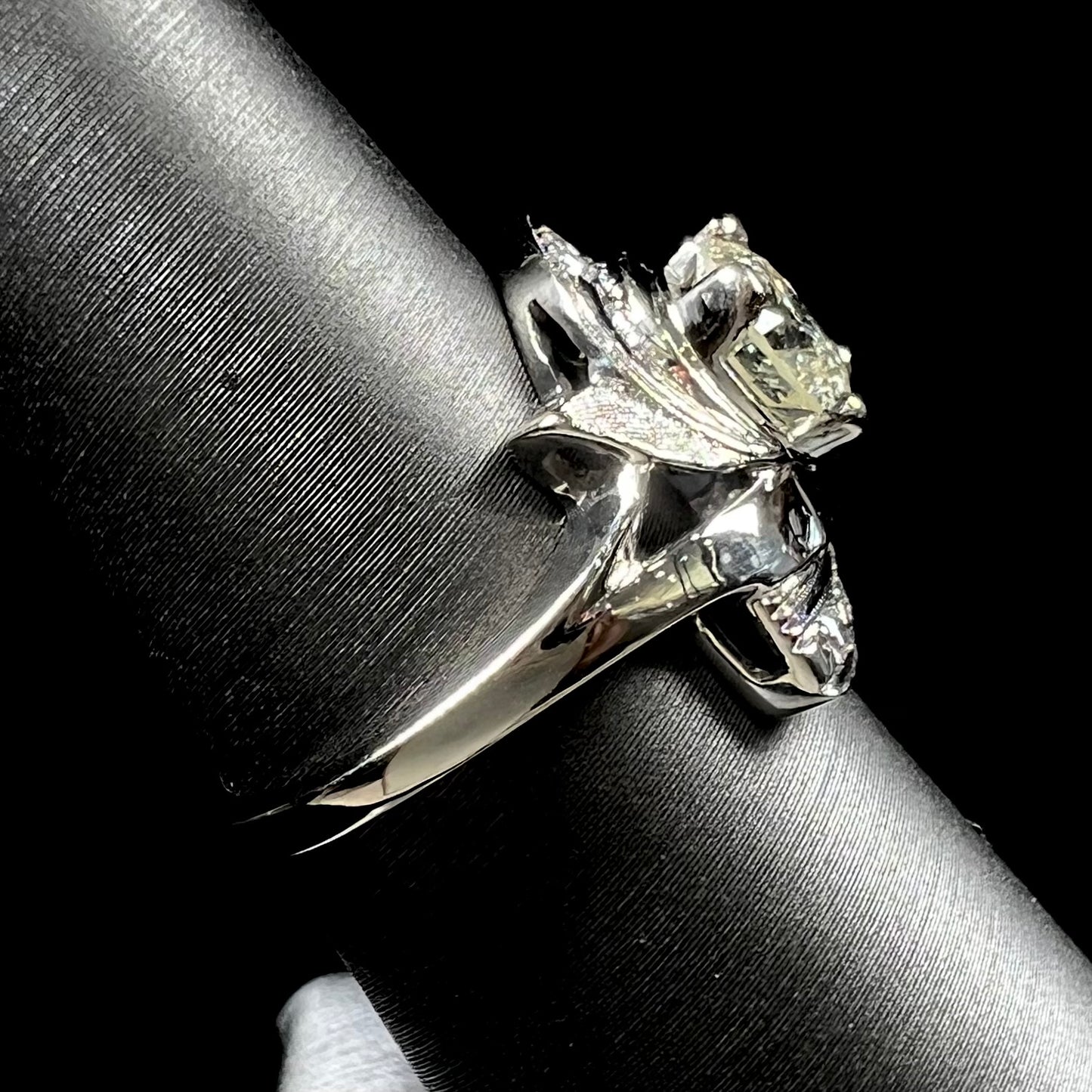 A vintage, Art Nouveau style diamond engagment ring.  The ring is white gold with a yellowish, M colored, 1.24 carat diamond.