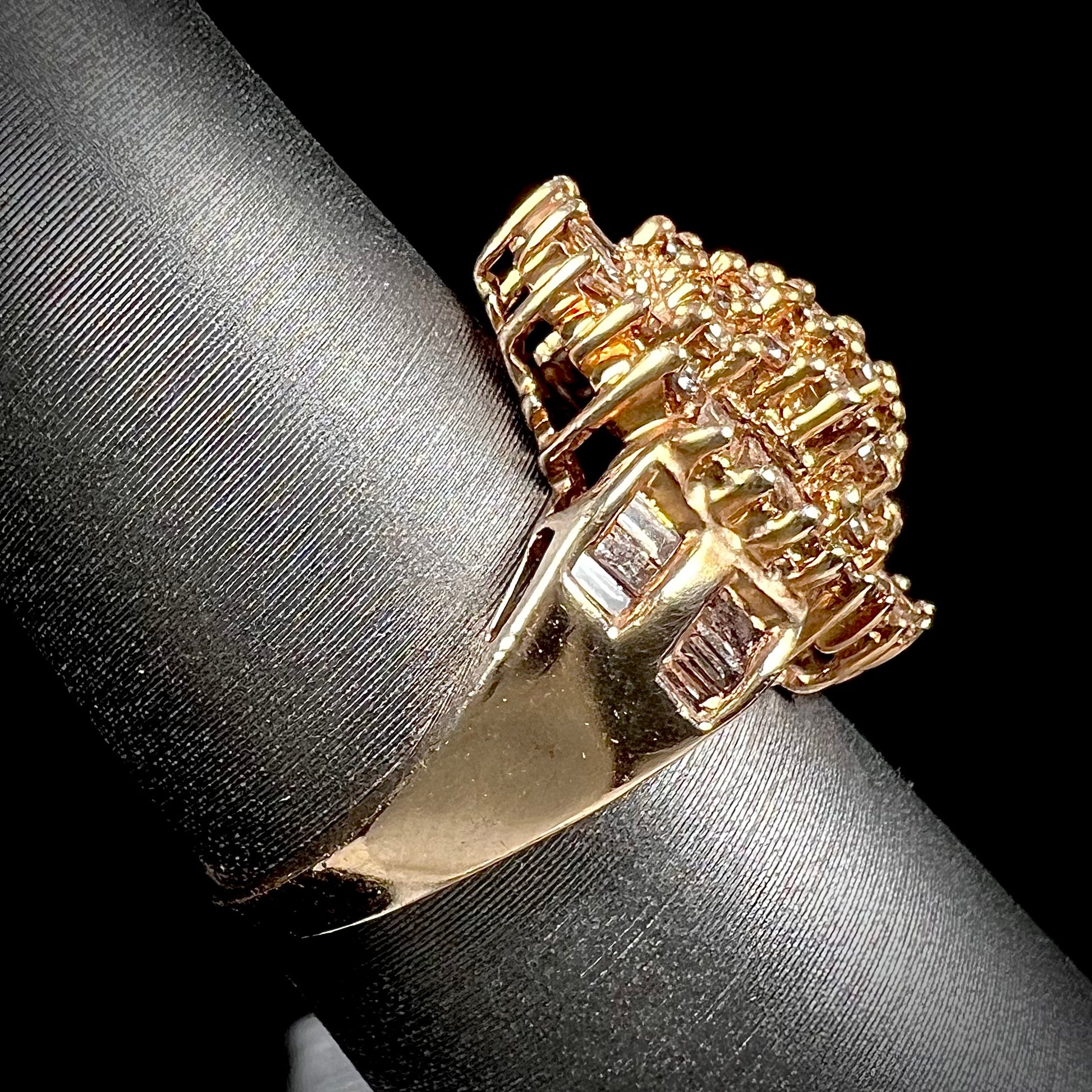 A ladies' cluster ring set with round and baguette cut cognac brown diamonds.