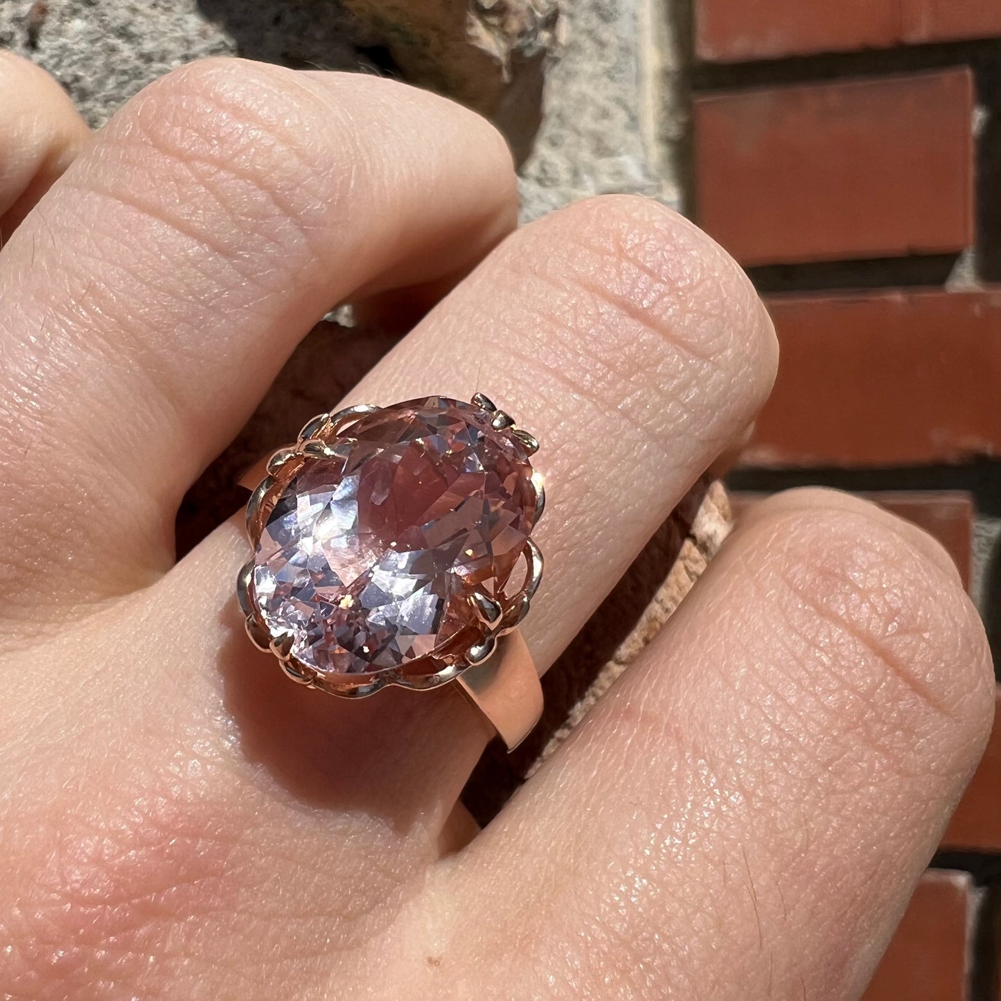 A ladies' rose gold solitaire ring set with an oval cut pink morganite gemstone.