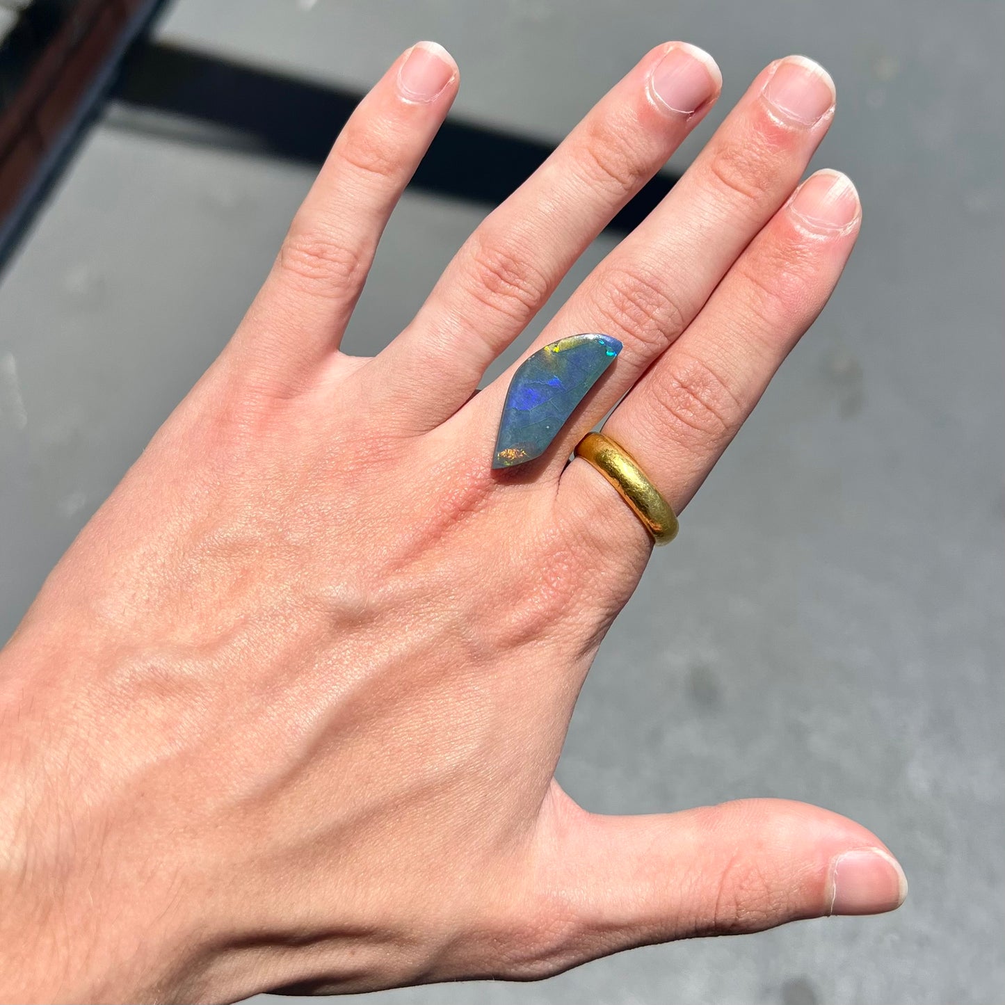 A loose black opal stone from Lightning Ridge, Australia. The opal's color plays from one particular direction.