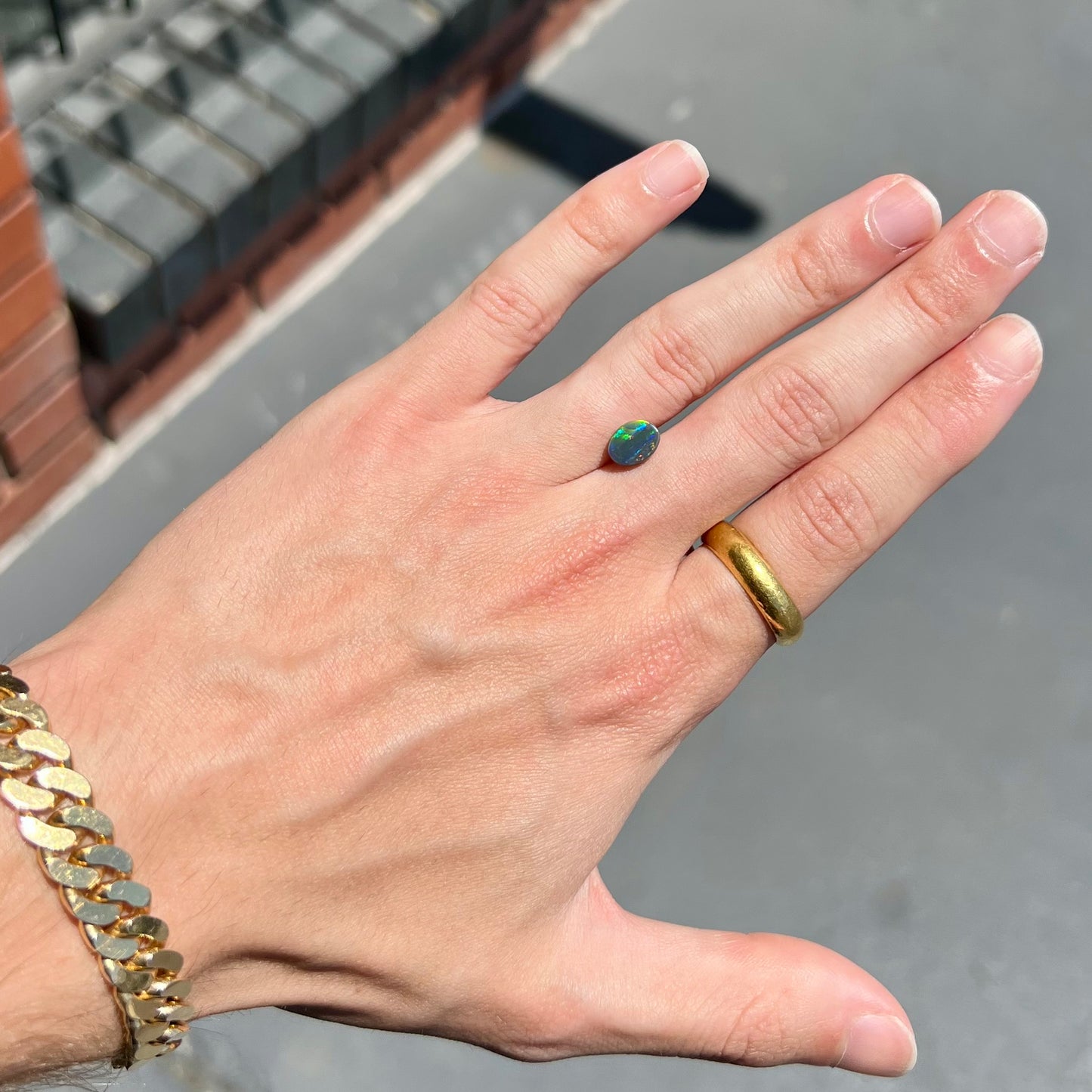 A loose, oval cut black opal from Lighting Ridge, Australia. The stone is highly directional.