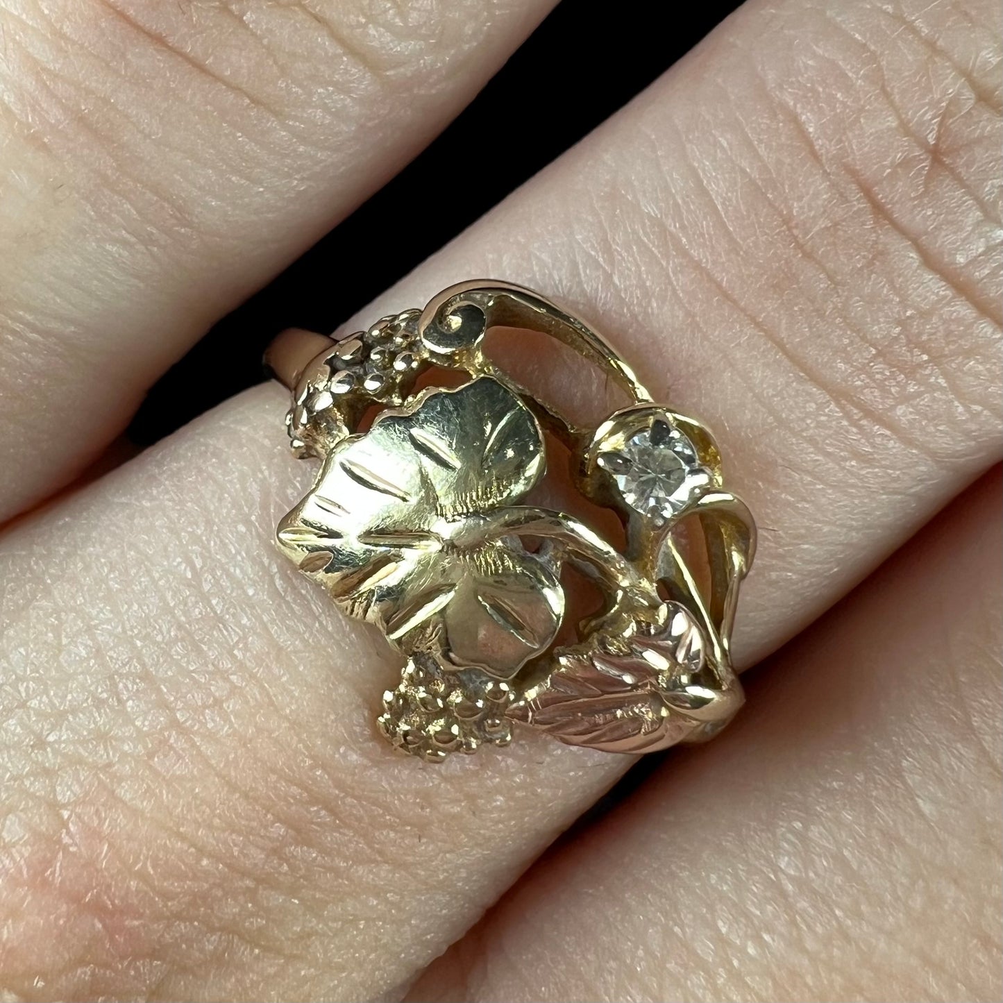 A ladies' two tone rose and yellow gold Black Hills gold diamond ring.  The ring exhibits a leaf design.