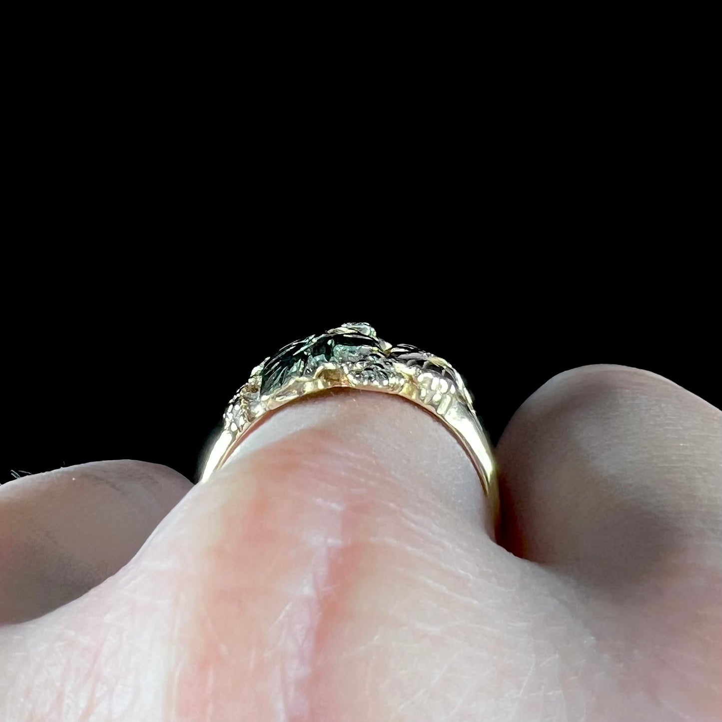 A ladies' two tone rose and yellow gold Black Hills gold diamond ring.  The ring exhibits a leaf design.