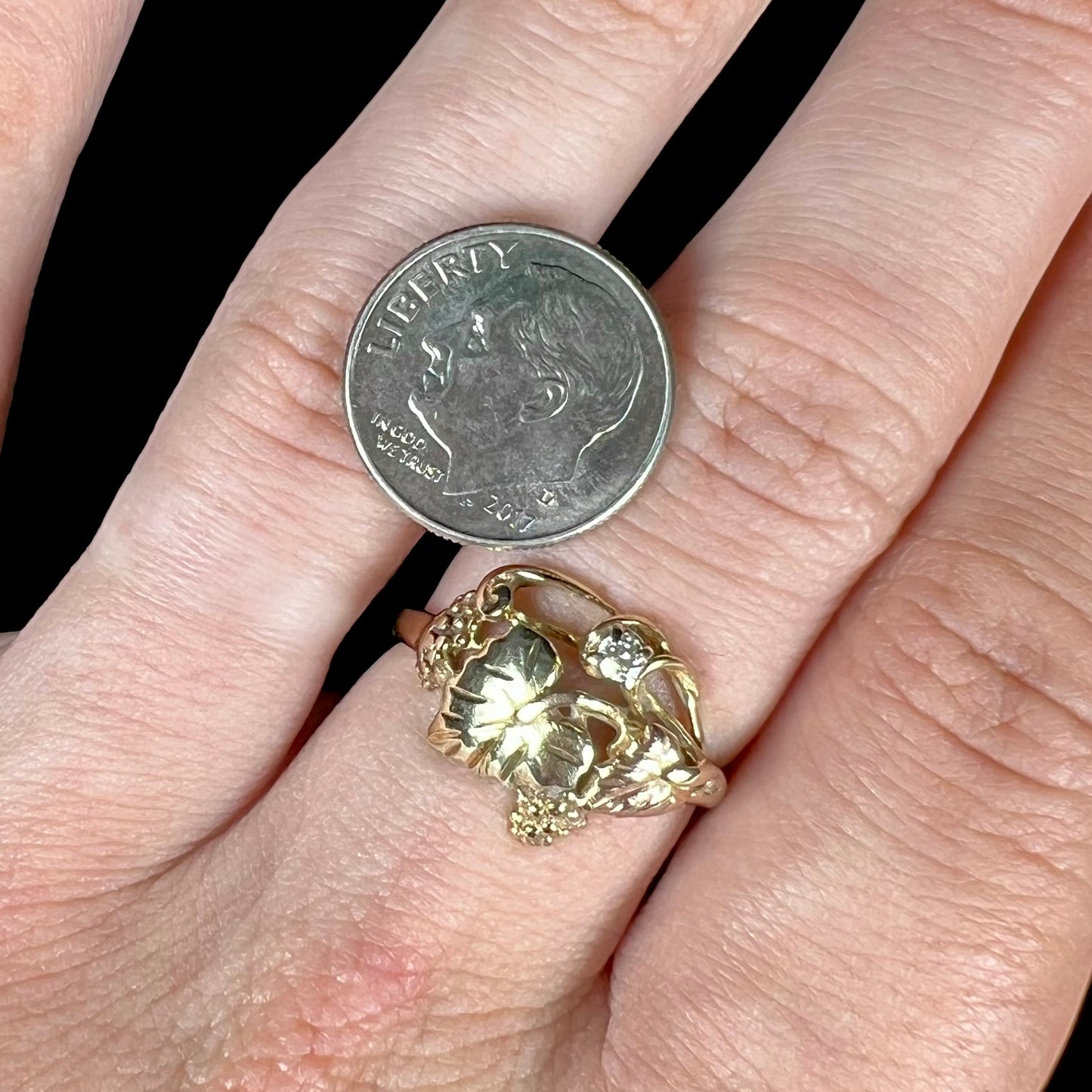 A ladies' two tone rose and yellow gold Black Hills gold diamond ring. The ring exhibits a leaf design.