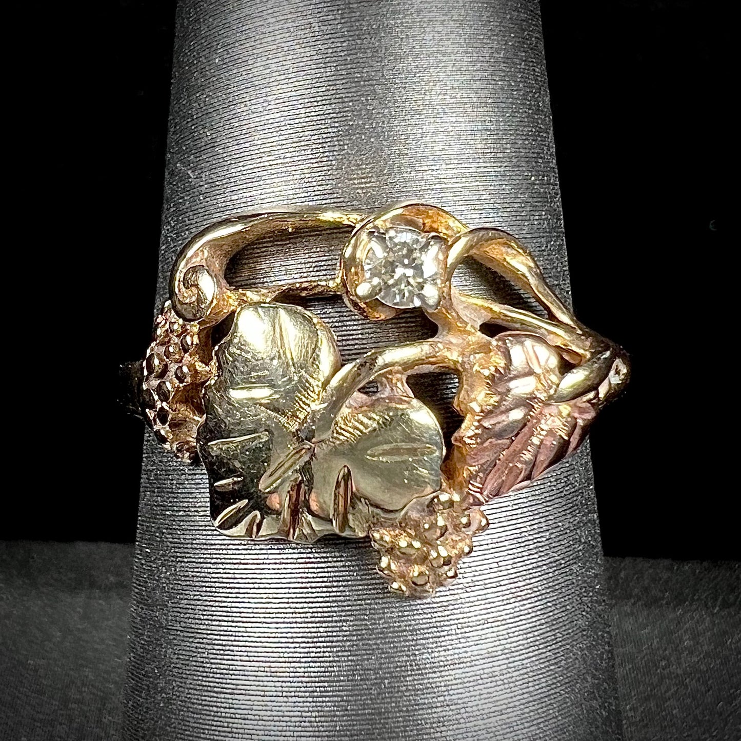 A ladies' two tone rose and yellow gold Black Hills gold diamond ring. The ring exhibits a leaf design.