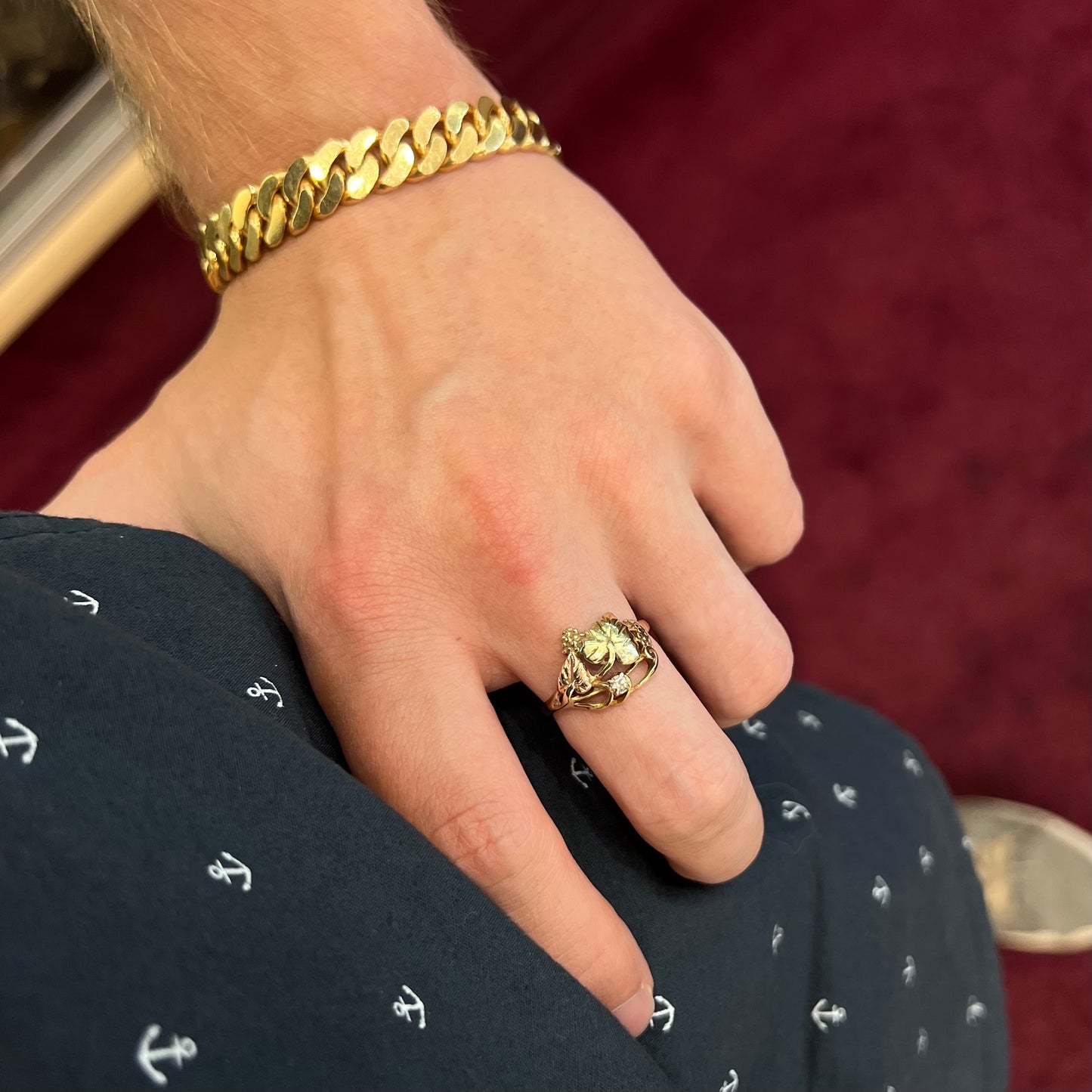 A ladies' two tone rose and yellow gold Black Hills gold diamond ring. The ring exhibits a leaf design.