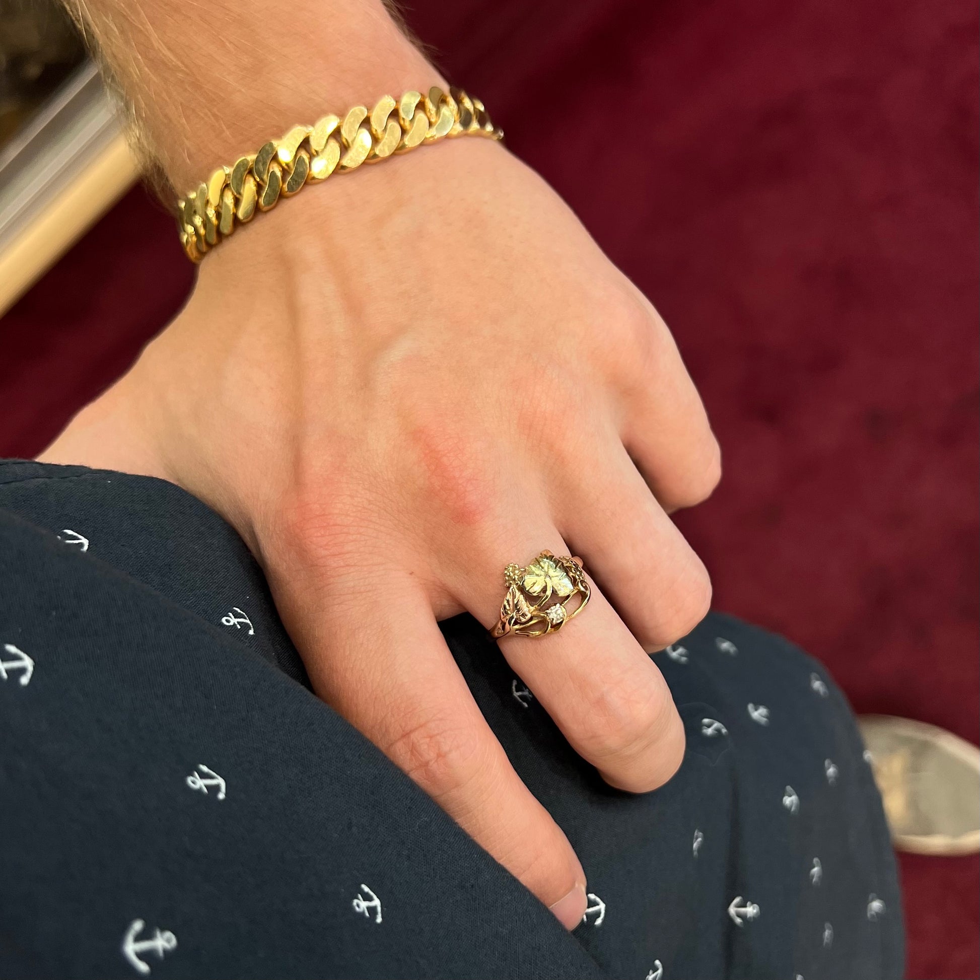 A ladies' two tone rose and yellow gold Black Hills gold diamond ring.  The ring exhibits a leaf design.