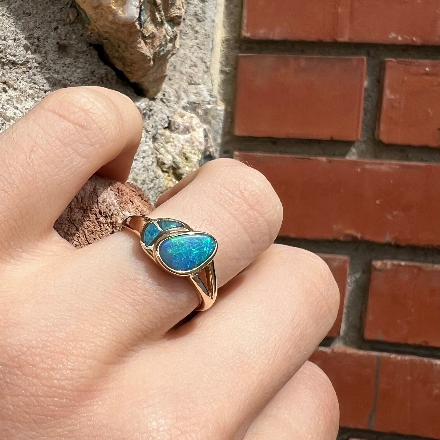 A ladies' black opal inlay ring cast in yellow gold.