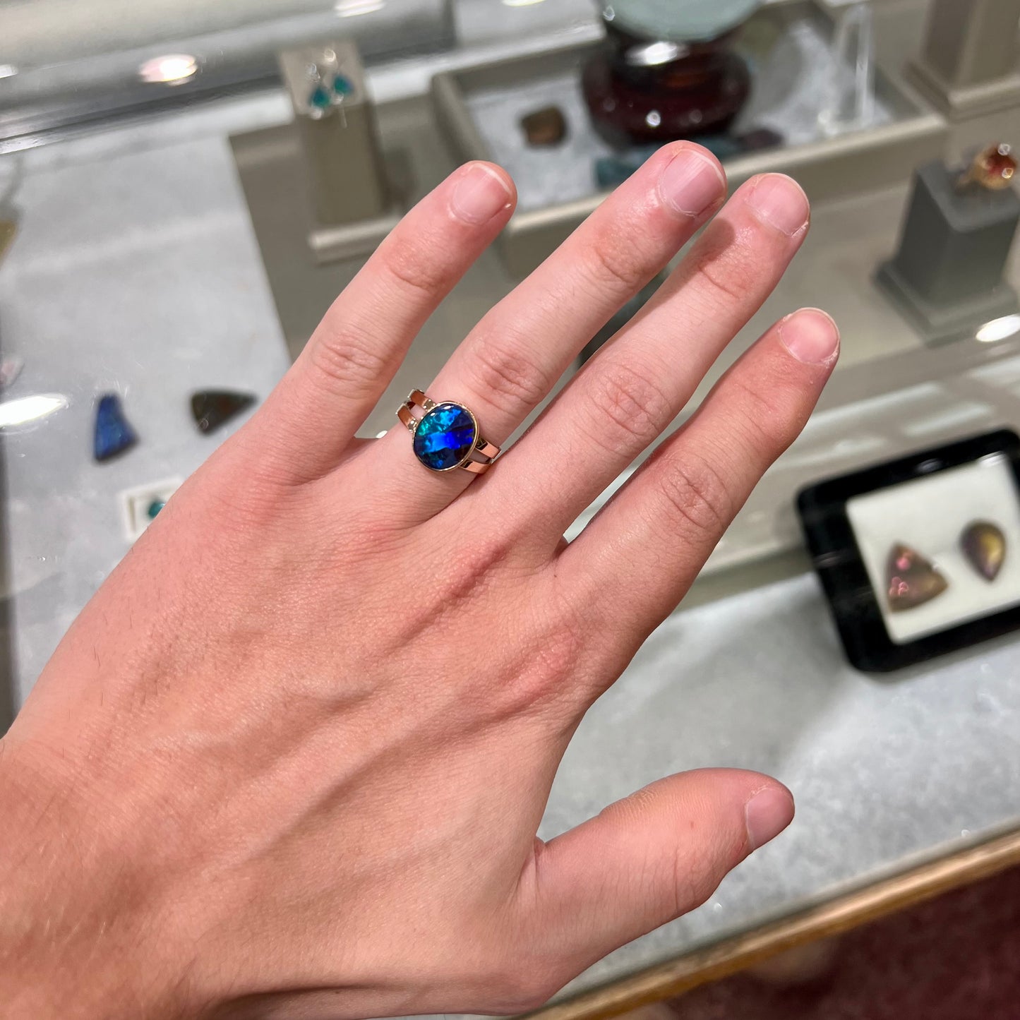 A ladies' split shank natural, Lightning Ridge, Australian black opal solitaire ring in yellow gold.