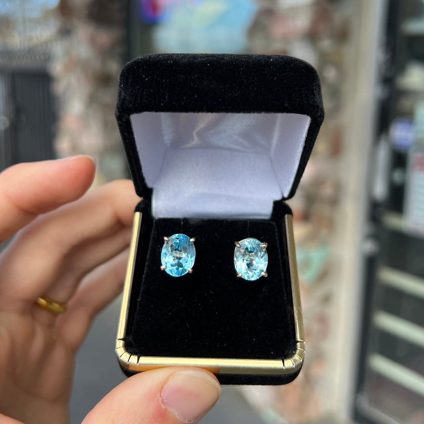 A pair of yellow gold push-back blue topaz stud earrings.