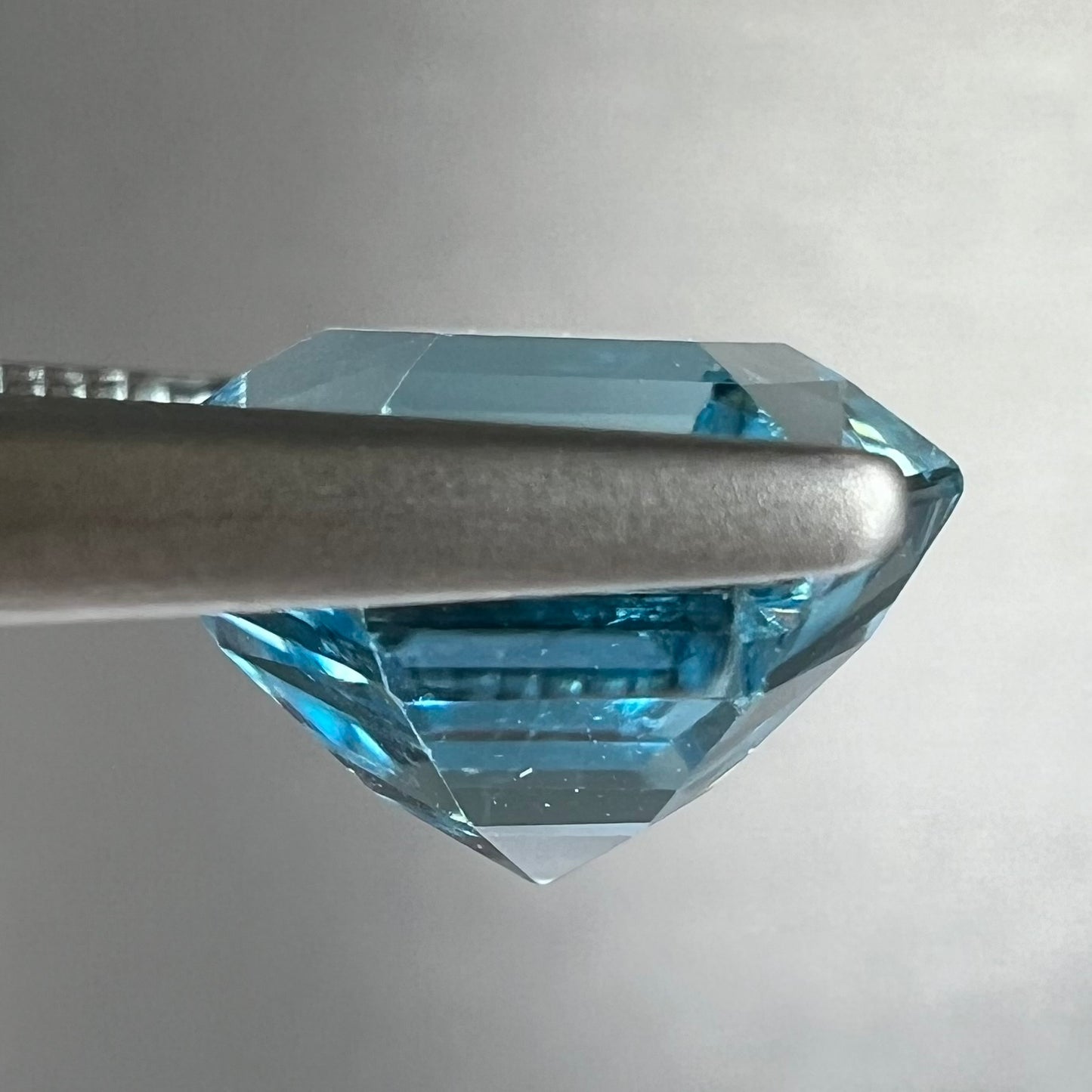 A faceted hexagon cut sky blue topaz gemstone.