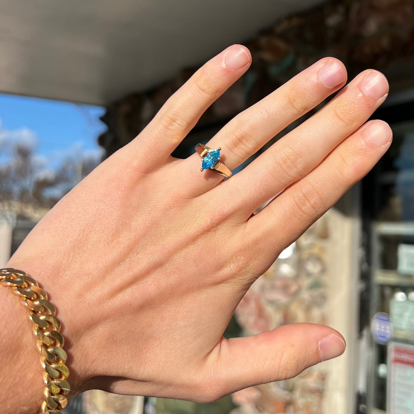 A ladies' estate yellow gold ring, prong set with a marquise cut blue topaz stone. There are scratches on the shank.