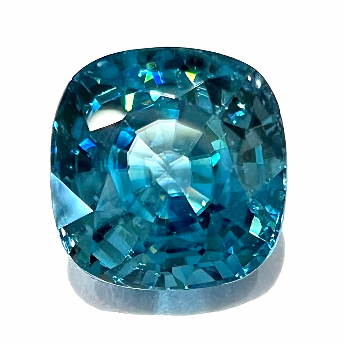 A loose cushion cut blue zircon stone.  The gem weighs 4.04 carats.