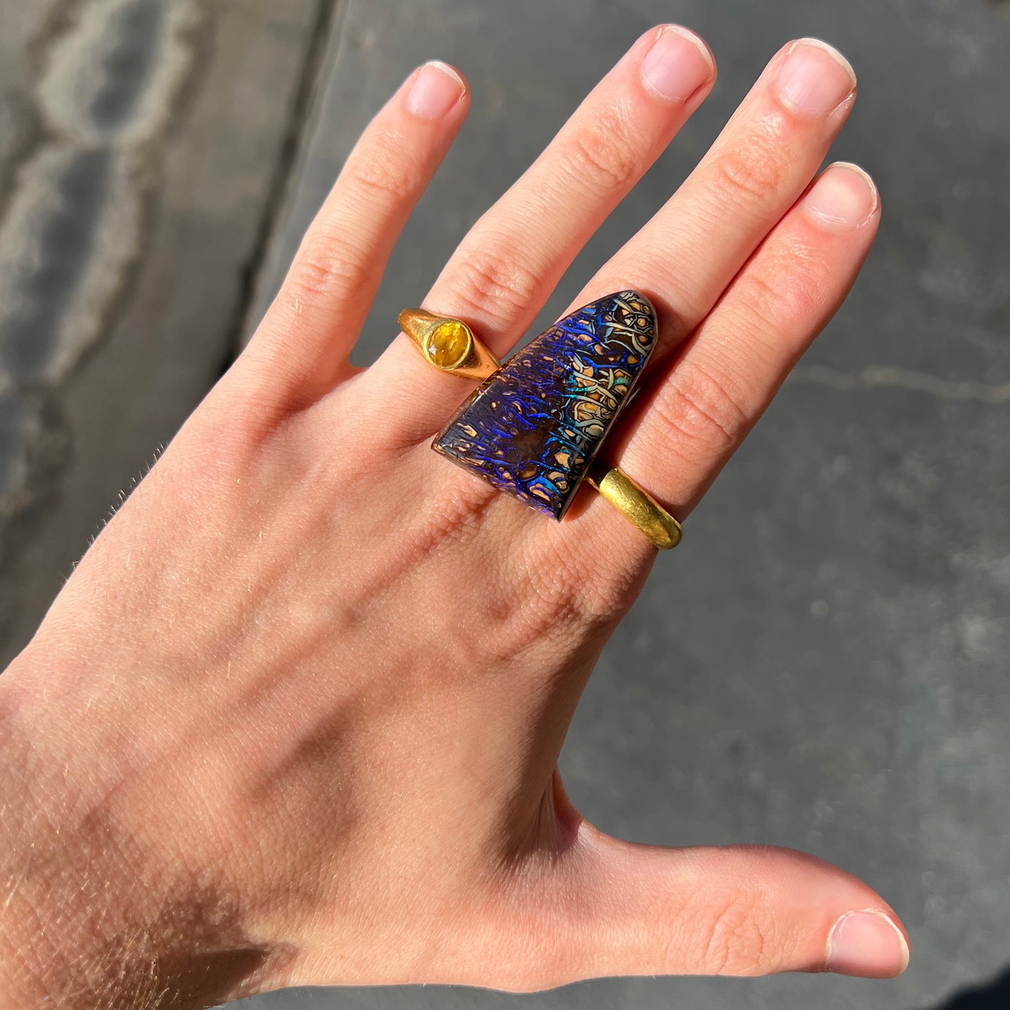 A loose boulder opal stone from Koroit, Australia. The opal has a blue and purple pattern.
