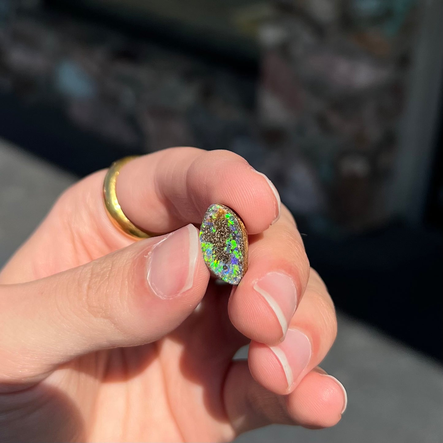 A loose boulder opal stone from Quilpie, Australia. The opal has bright green and blue flashes.