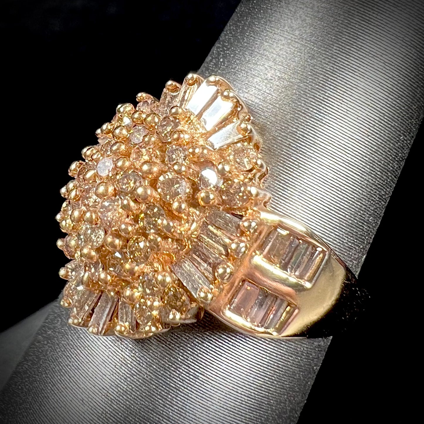 A ladies' cluster ring set with round and baguette cut cognac brown diamonds.