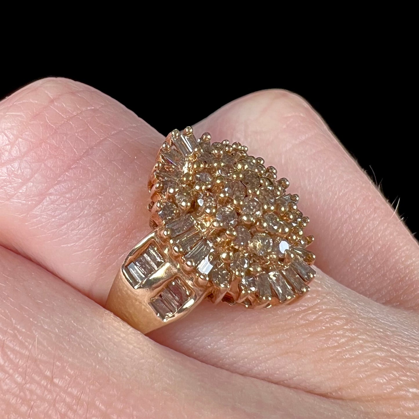 A ladies' cluster ring set with round and baguette cut cognac brown diamonds.