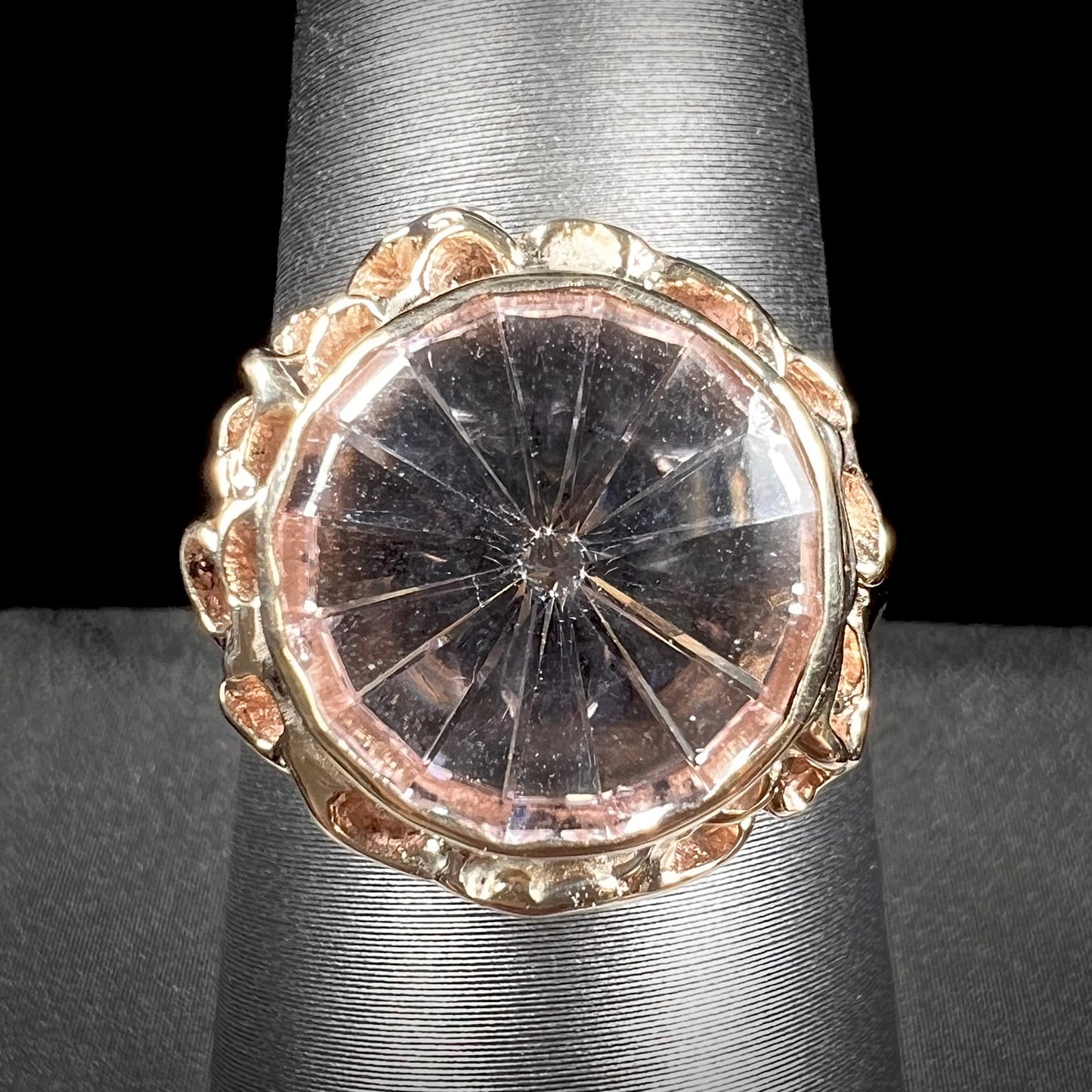 A ladies' yellow gold solitaire ring bezel set with a modified bud cut morganite gemstone.