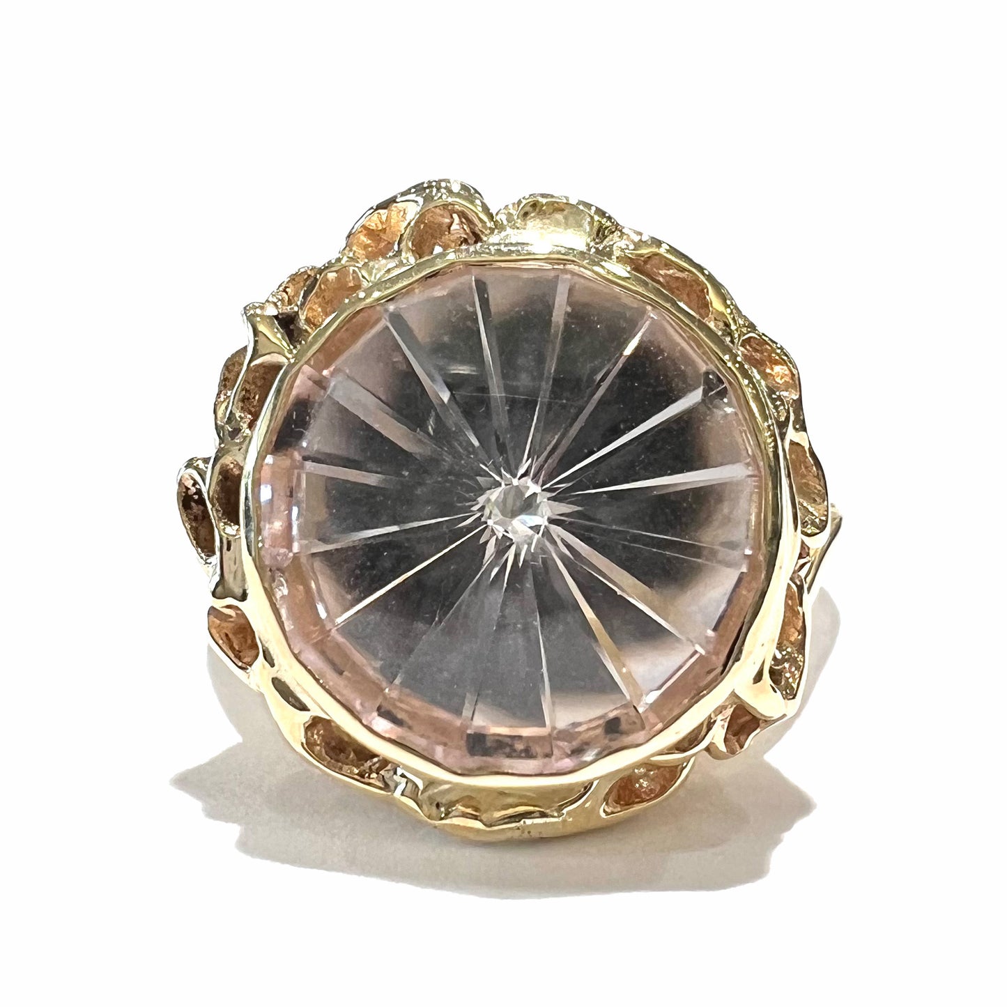 A ladies' yellow gold solitaire ring bezel set with a modified bud cut morganite gemstone.