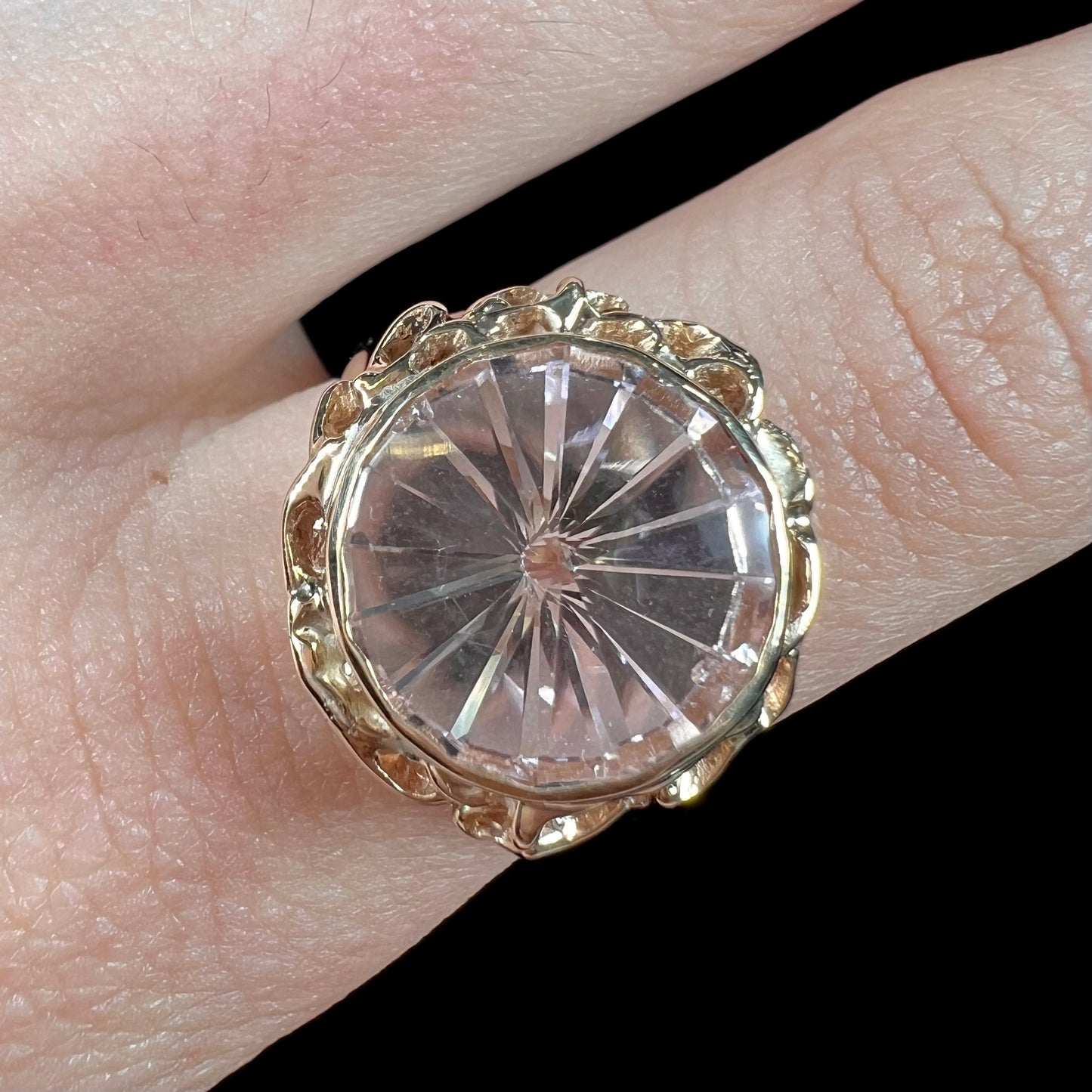 A ladies' yellow gold solitaire ring bezel set with a modified bud cut morganite gemstone.