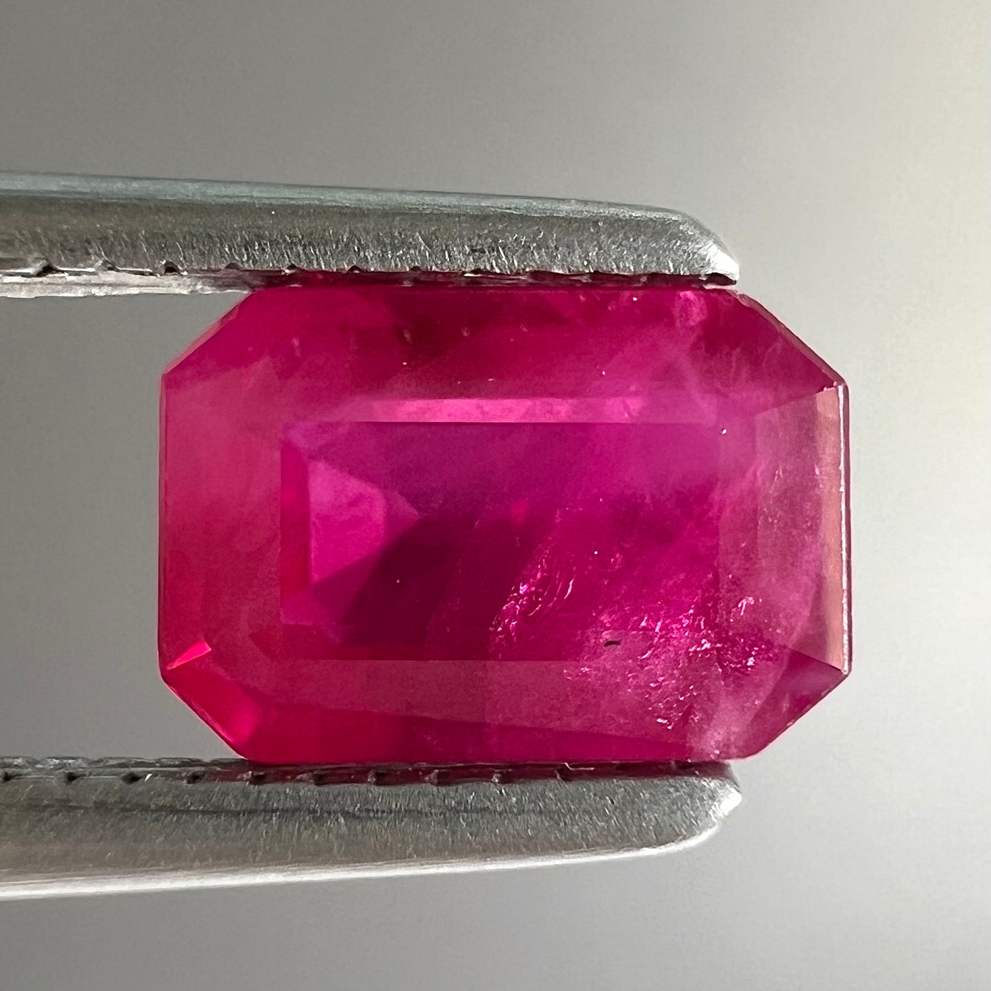 A natural, emerald cut Burma ruby gemstone.  The stone is pinkish red color.
