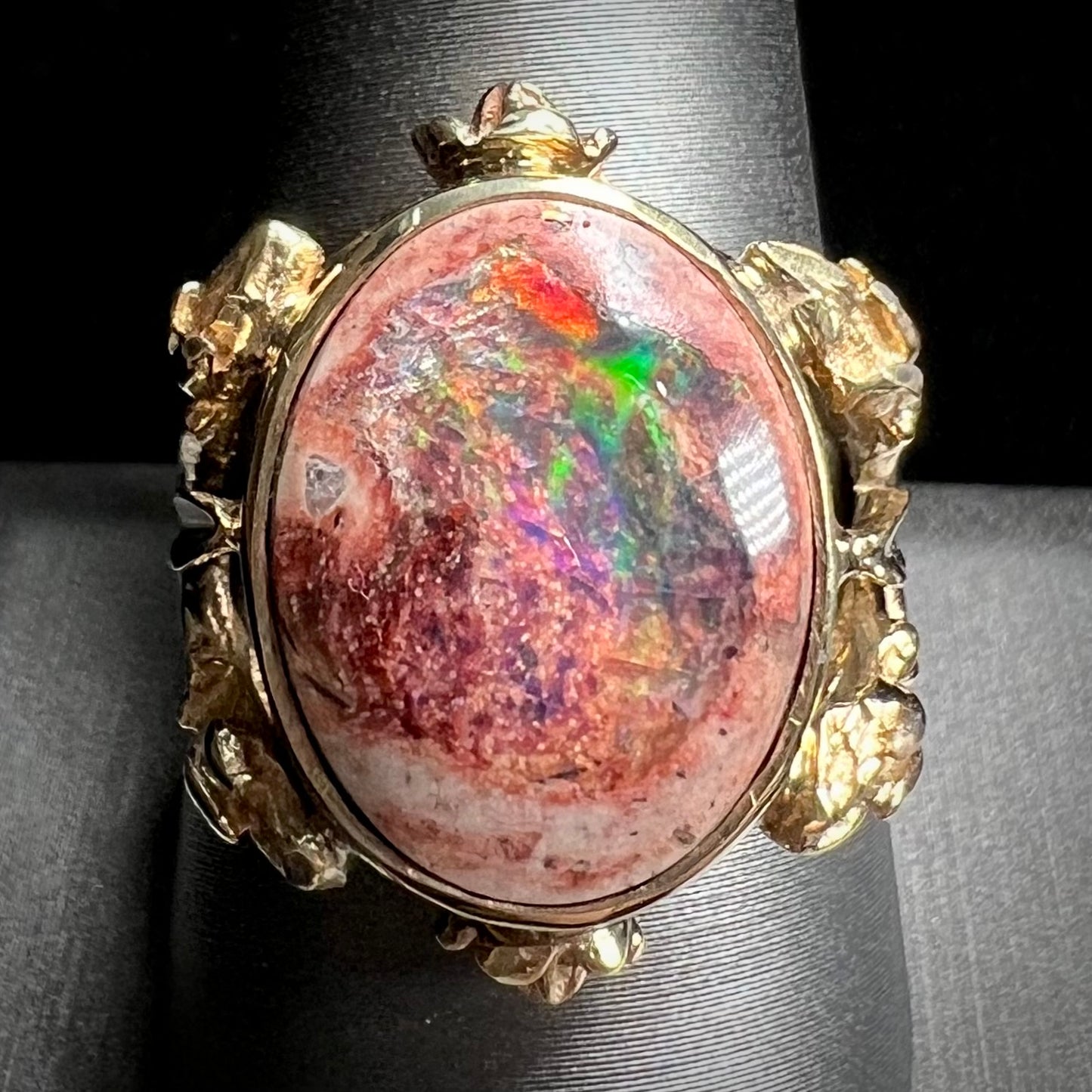 A ladies' estate yellow gold solitaire ring set with an oval cabochon cut natural Cantera fire opal.
