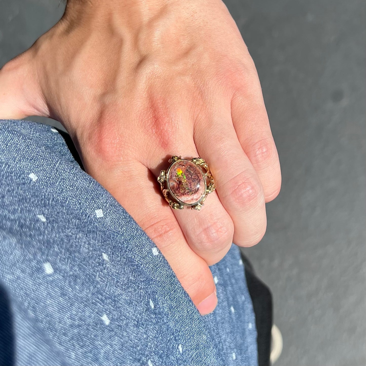 A ladies' estate yellow gold solitaire ring set with an oval cabochon cut natural Cantera fire opal.