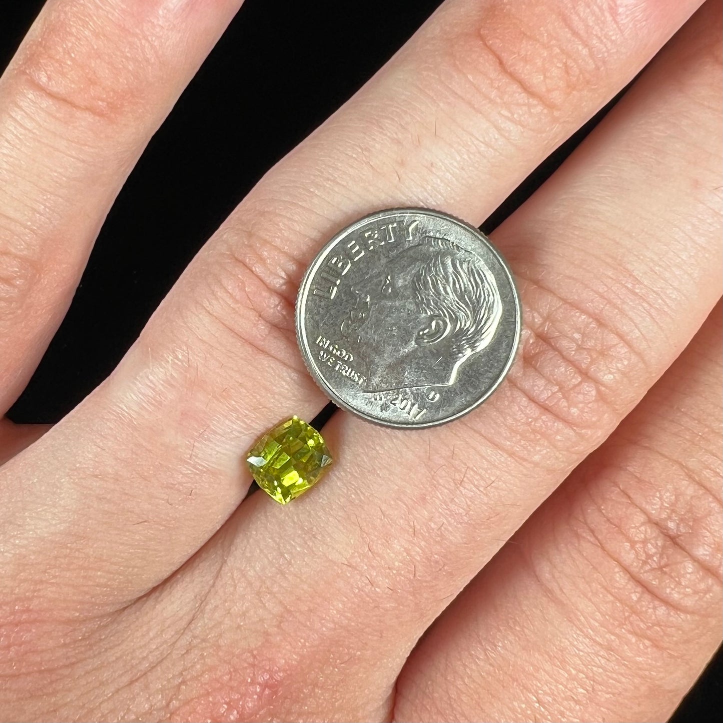 A loose, modified cushion cut greenish yellow chrysoberyl gemstone.