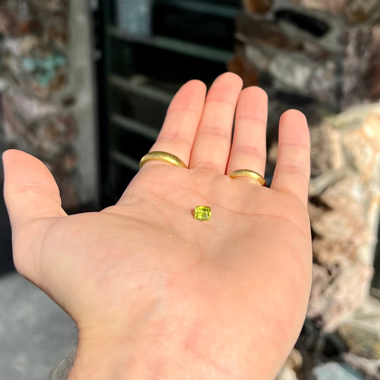 A loose, modified cushion cut greenish yellow chrysoberyl gemstone.