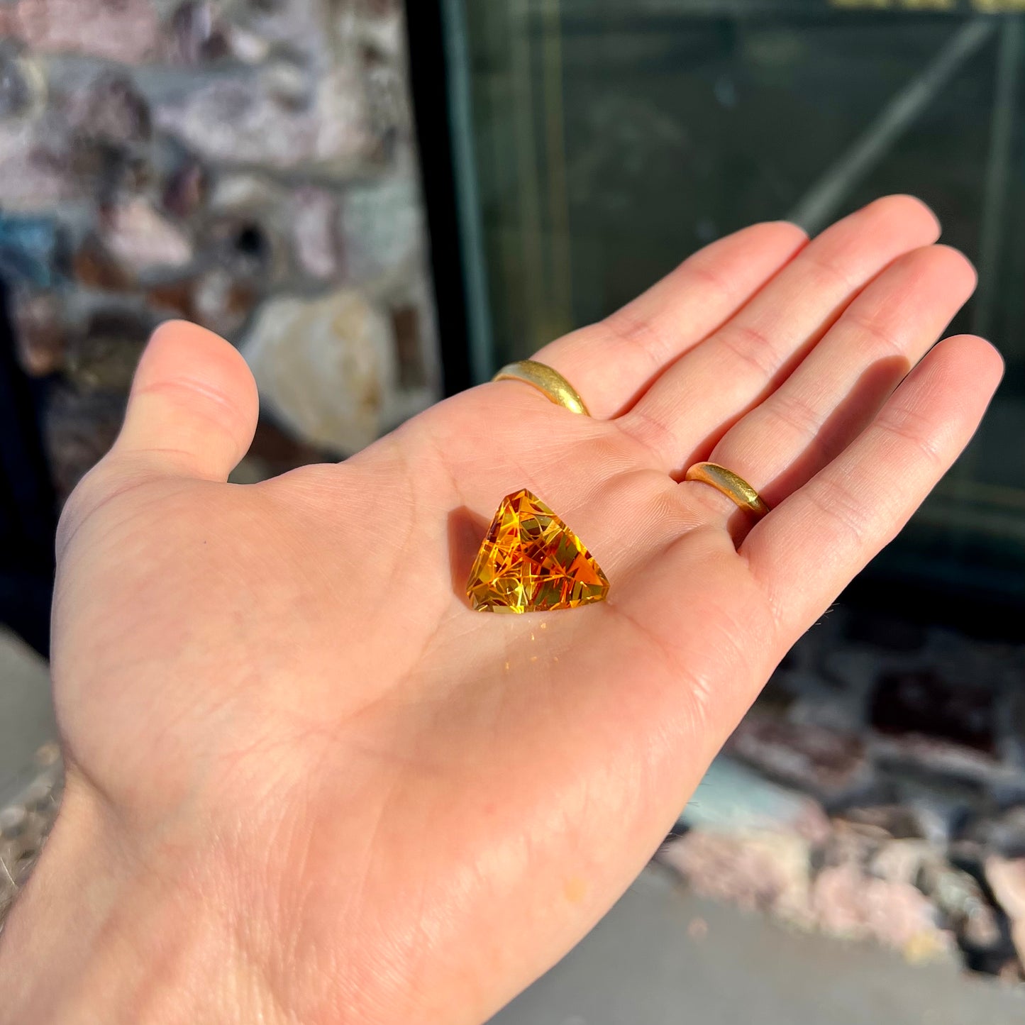 A loose, triangular fantasy cut yellow citrine stone cut by Arthur Lee Anderson.