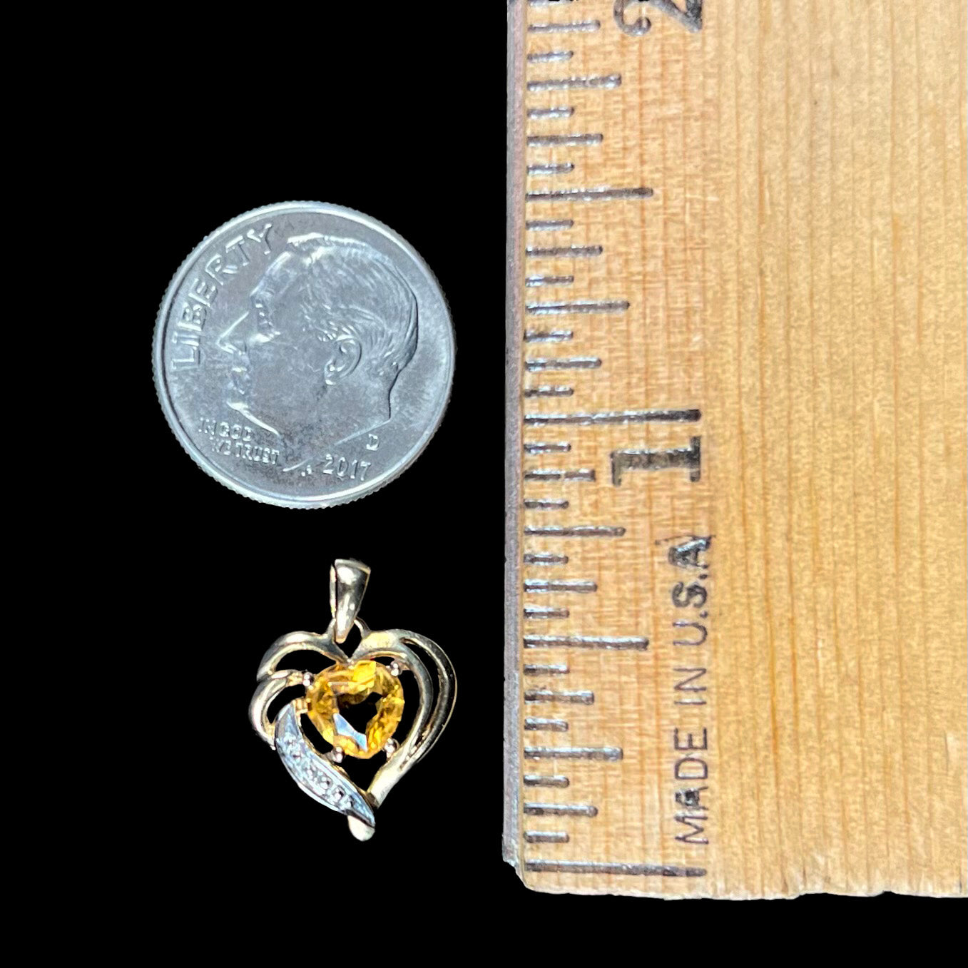 A ladies' yellow gold pendant set with a heart cut citrine stone and a diamond accent.