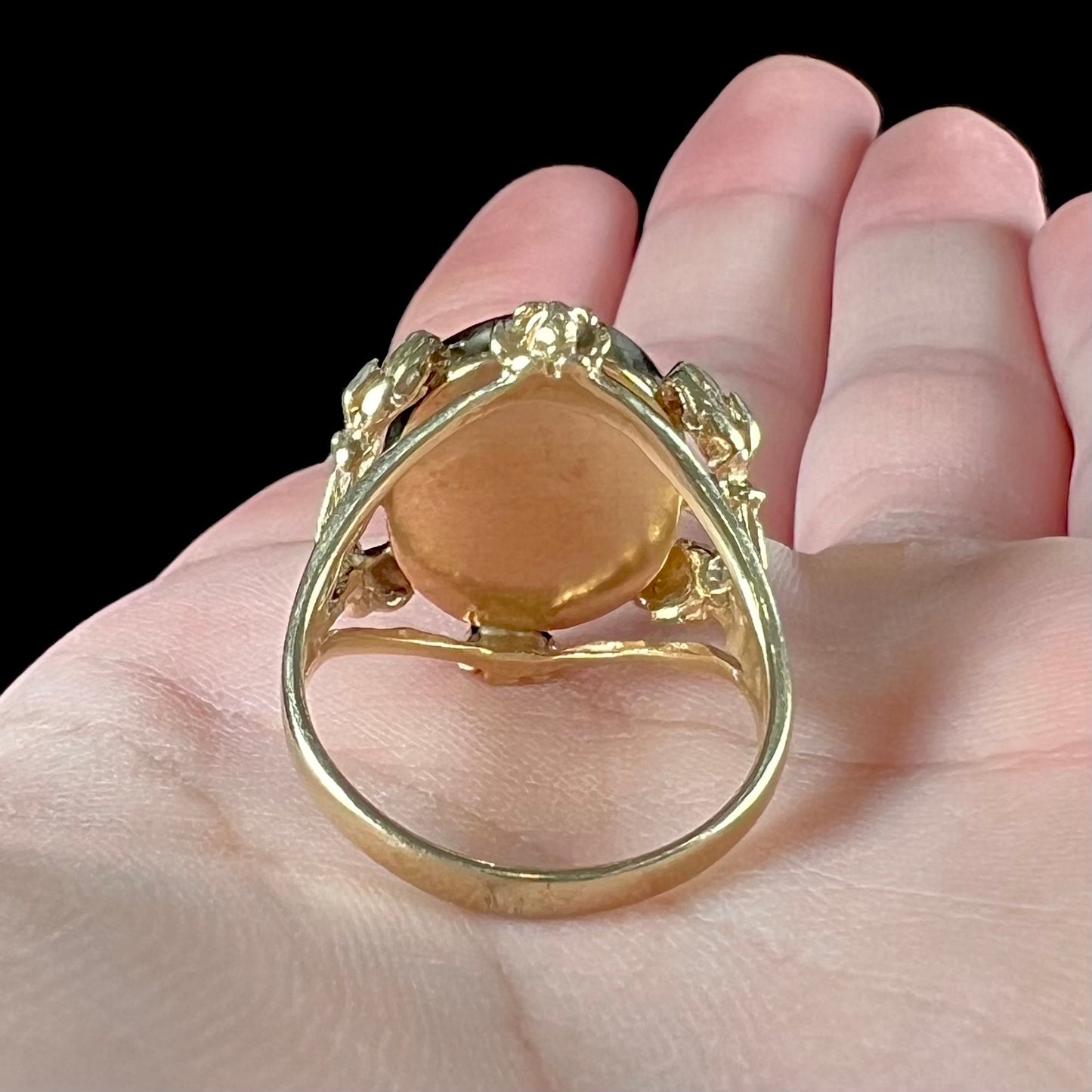 A ladies' estate yellow gold solitaire ring set with an oval cabochon cut natural Cantera fire opal.