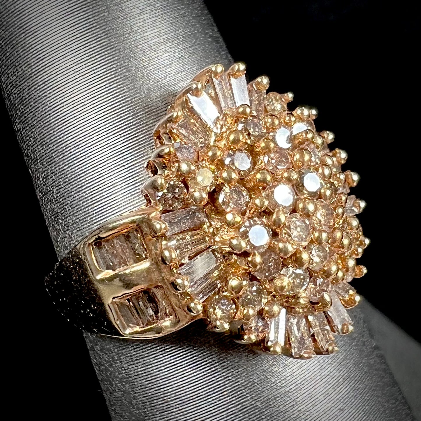 A ladies' cluster ring set with round and baguette cut cognac brown diamonds.