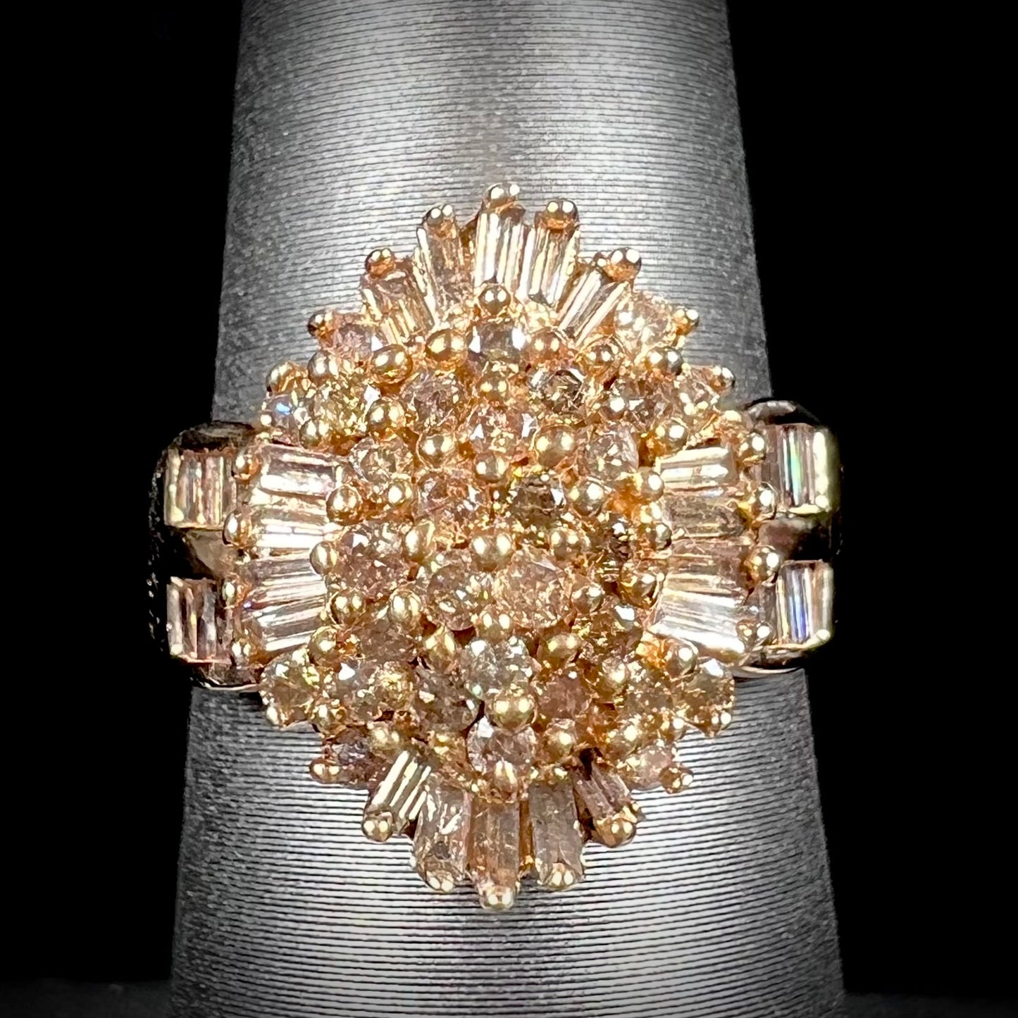 A ladies' cluster ring set with round and baguette cut cognac brown diamonds.