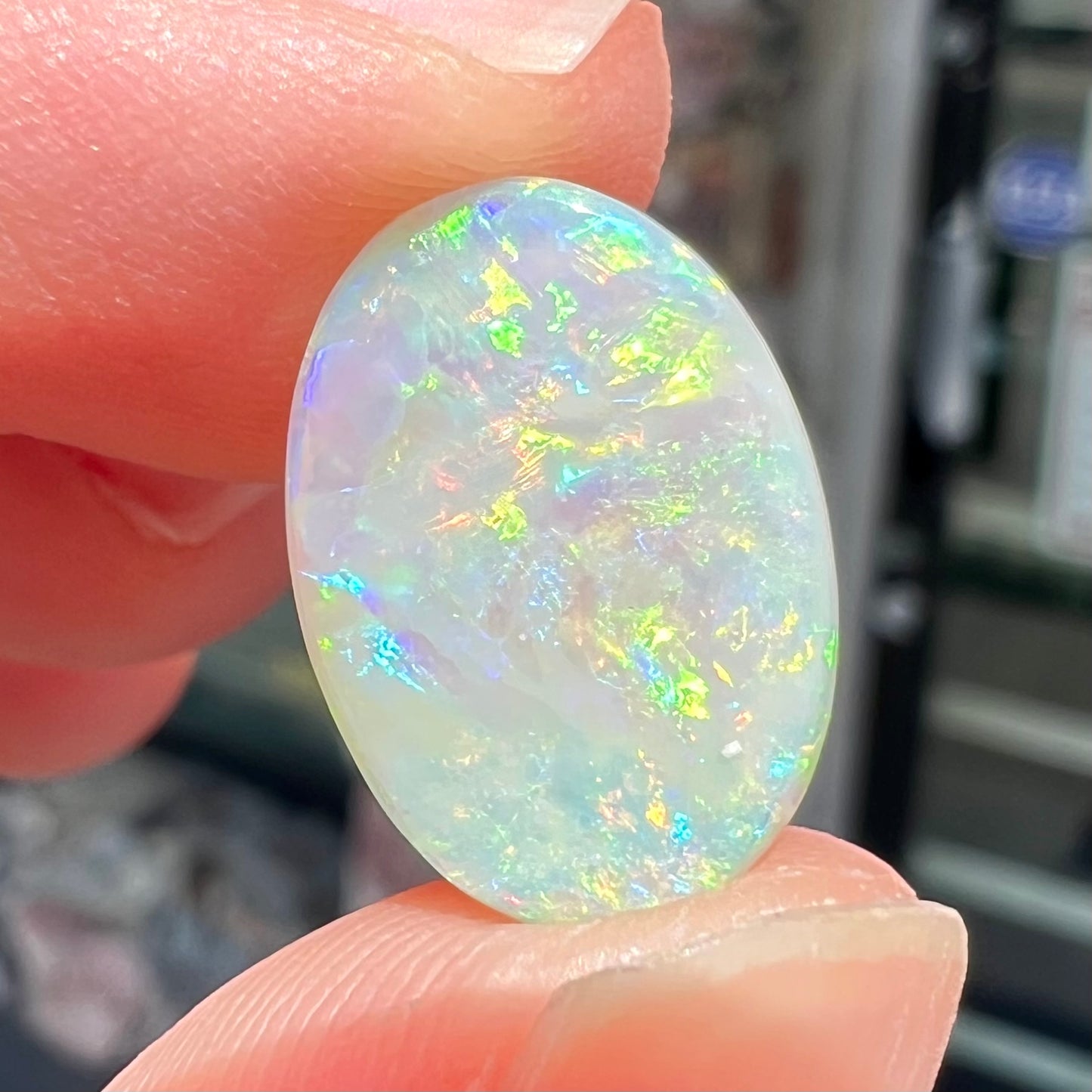A double-sided opal stone from Coober Pedy, Australia. The opal plays green, blue, and orange colors from the front and the back.
