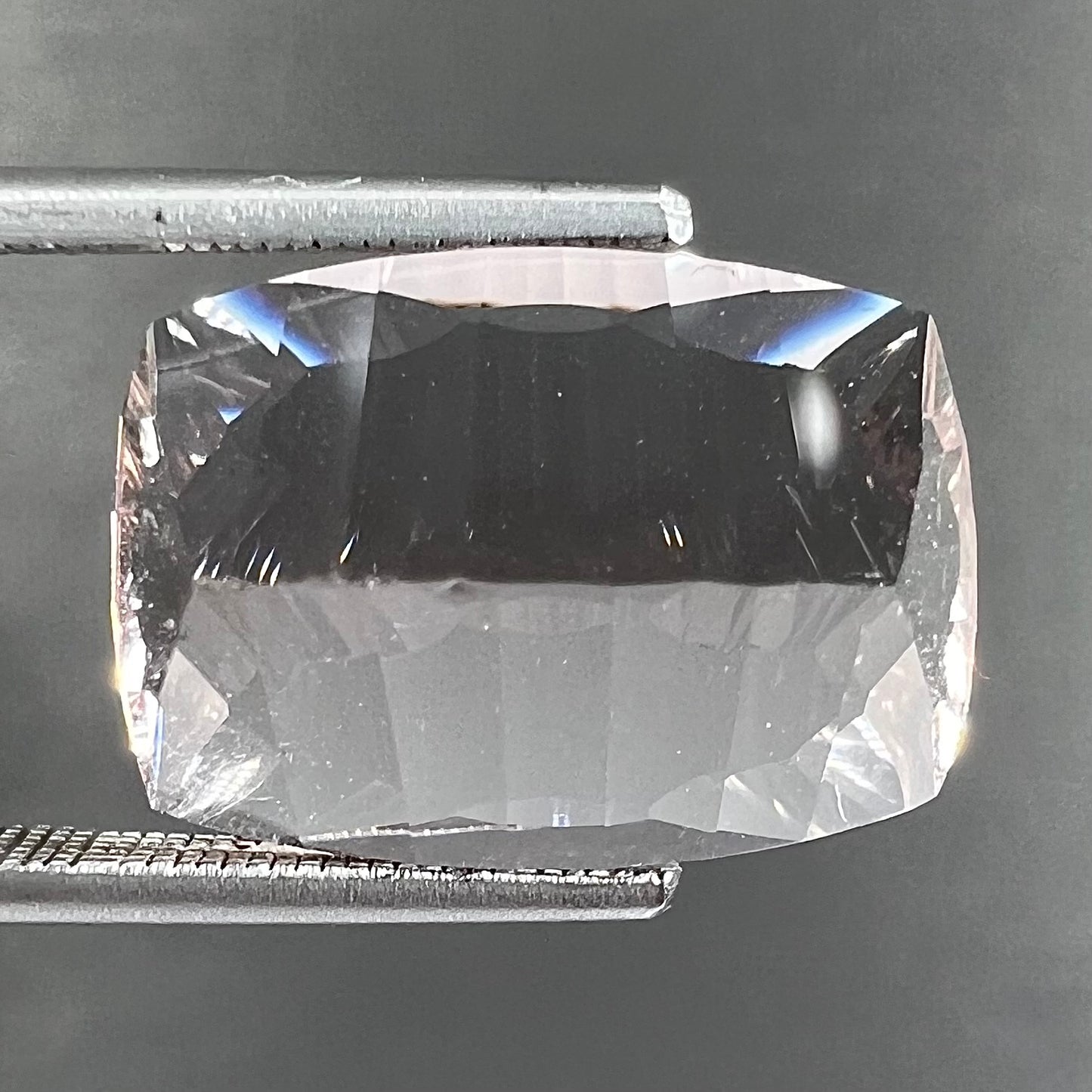 A loose, modified cushion cut pink morganite stone.