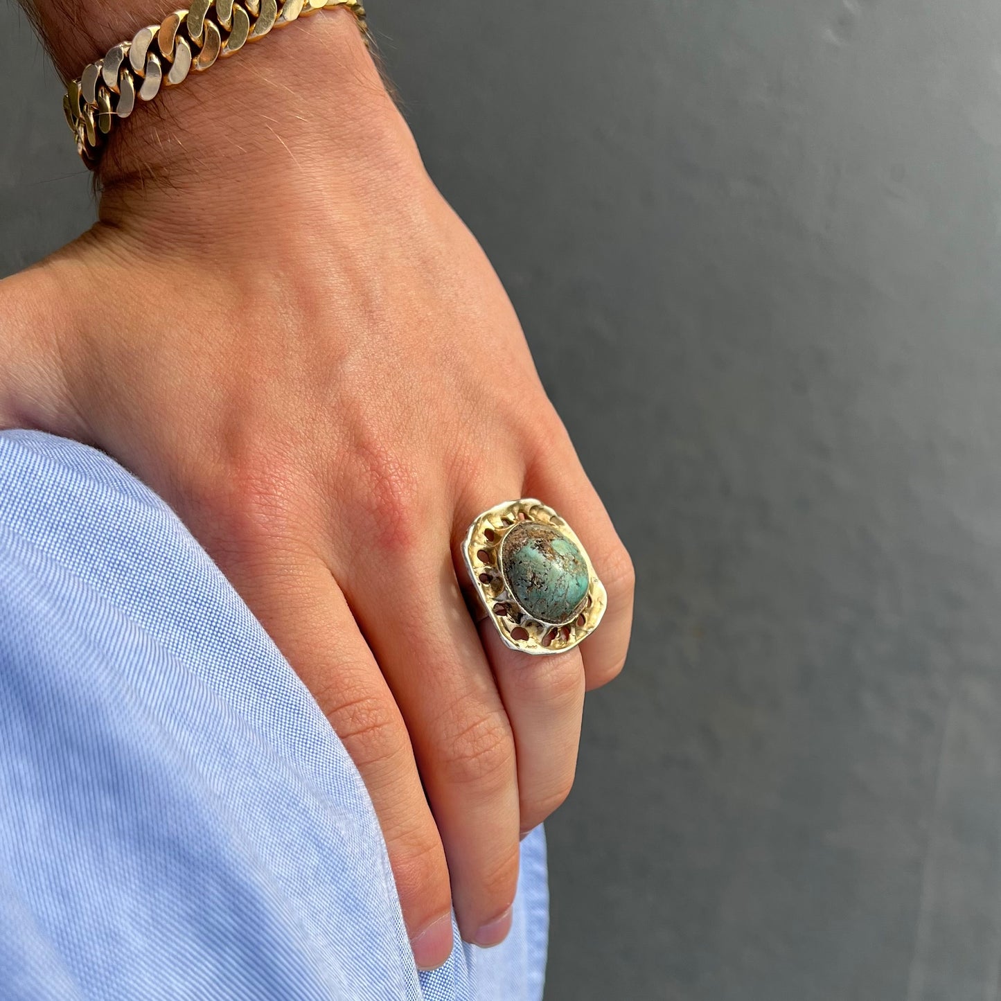 A unisex sterling silver ring with a gold wash, set with a natural, unstabilized Valley Blue turquoise stone.