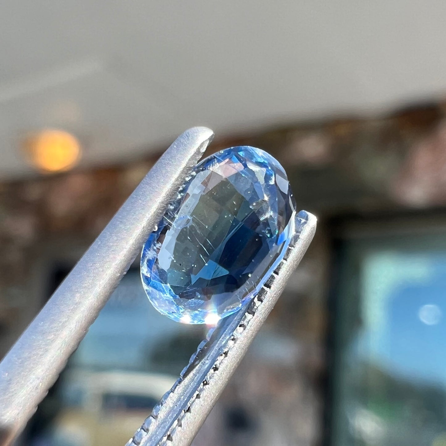 A loose, faceted oval cut blue kyanite gemstone.